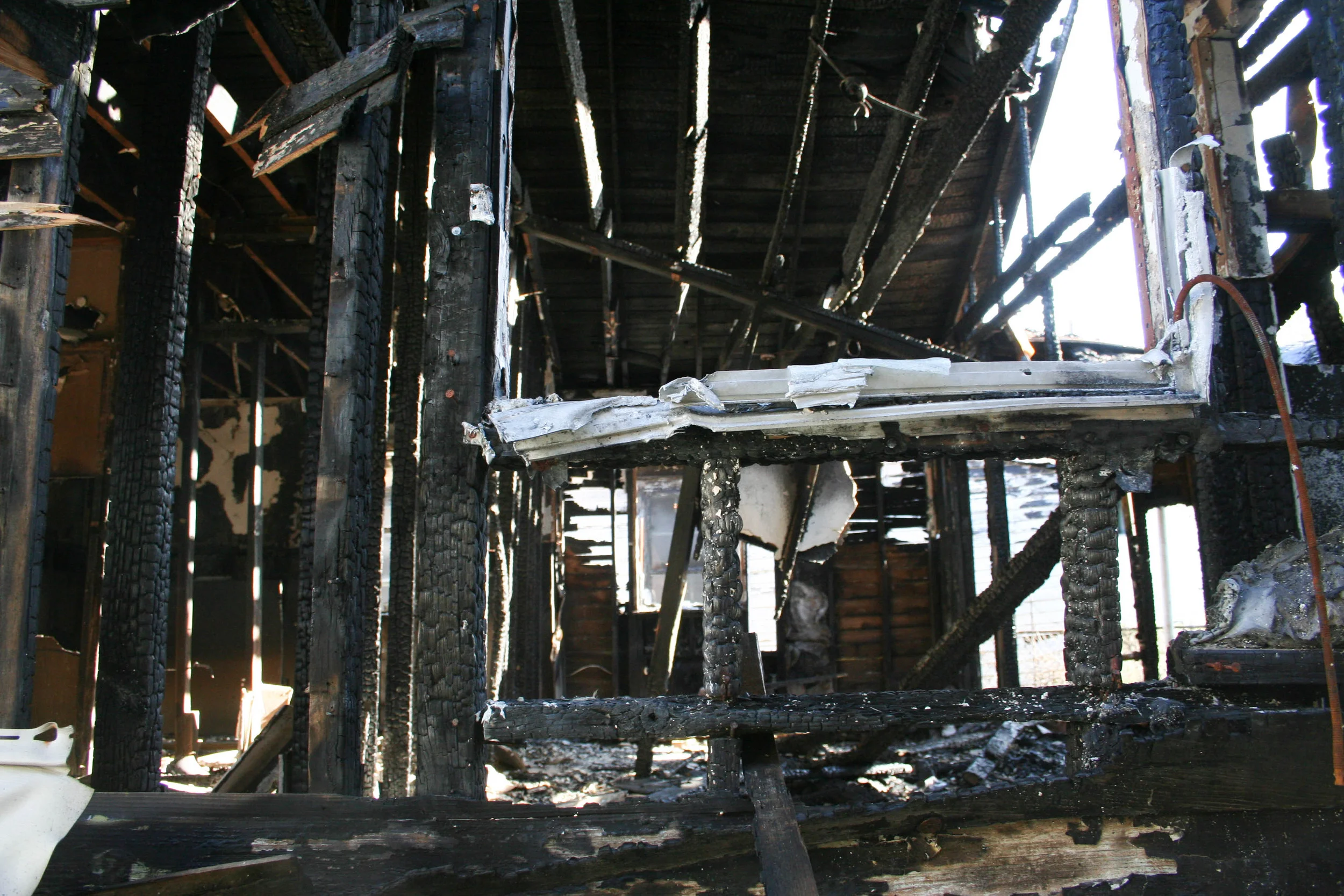  Neighboring house burnt down from a ruptured gas line during Hurricane Katrina. 