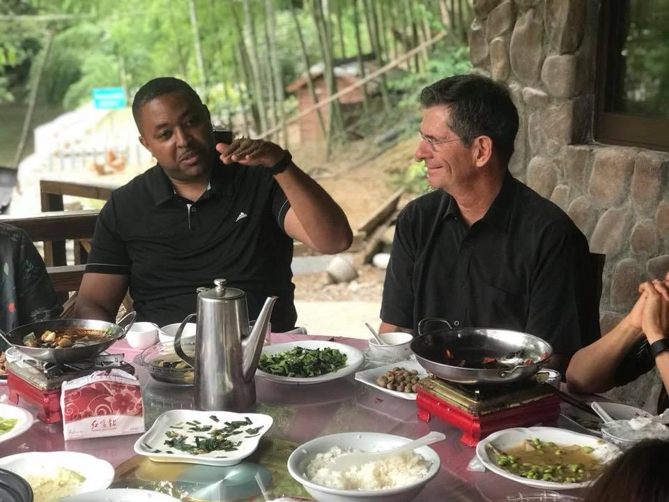 Kaleem Caire, CEO of Anji Play Pilot Partner One City Schools and One City Schools Board of Directors Vice-Chair Joe Krupp, relfect on their experience at Shuangyi Kindergarten over lunch in Shuangyi Village, Anji.