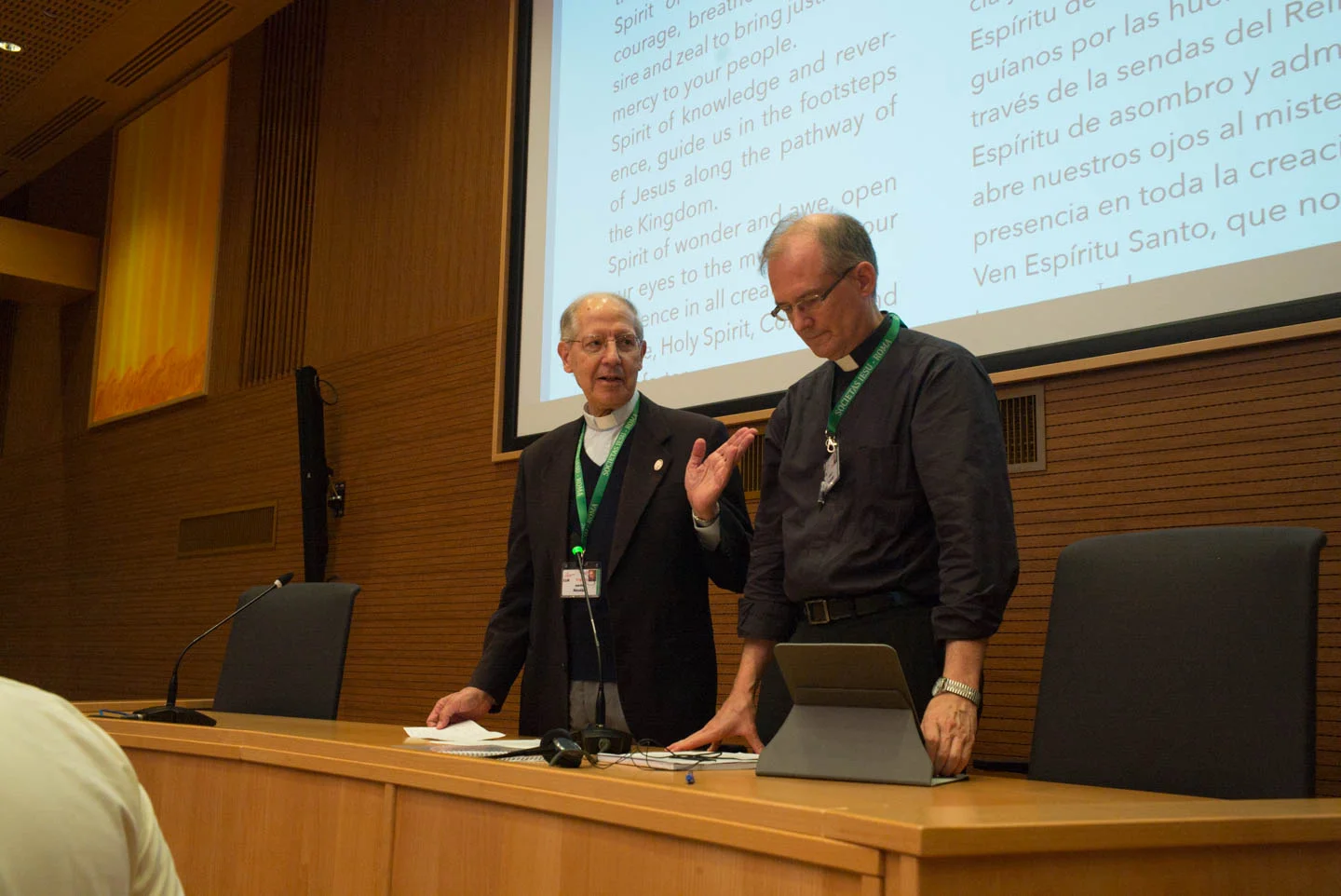 Adolfo Nicolás hands over the meeting to Jim Grummer, SJ, as vicar of GC36. Afterwards, Adolfo took his seat among the delegates for a few session before departing GC36.