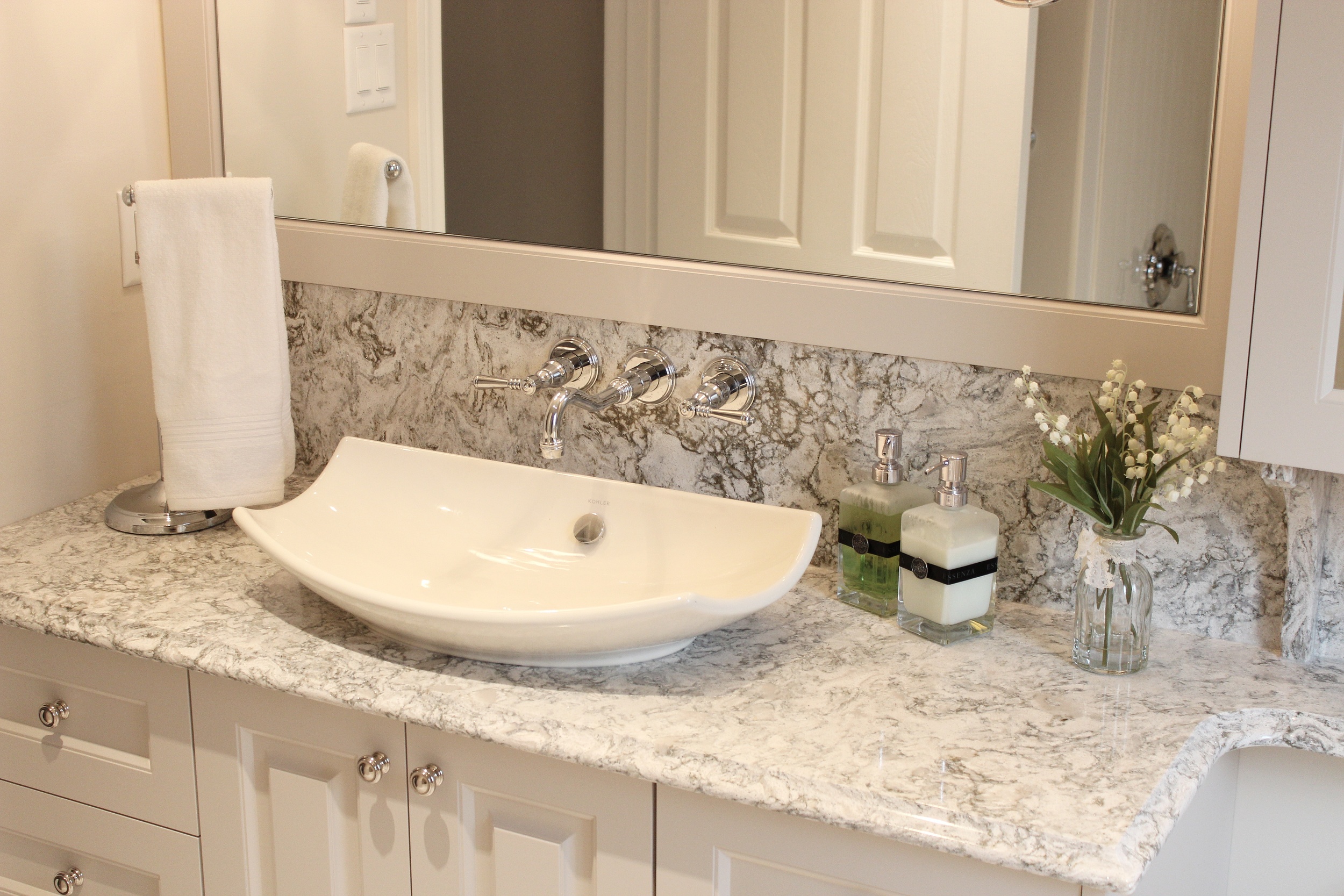 Vessel sink with water tapes mounted into the backsplash. This is as tricky as it looks!