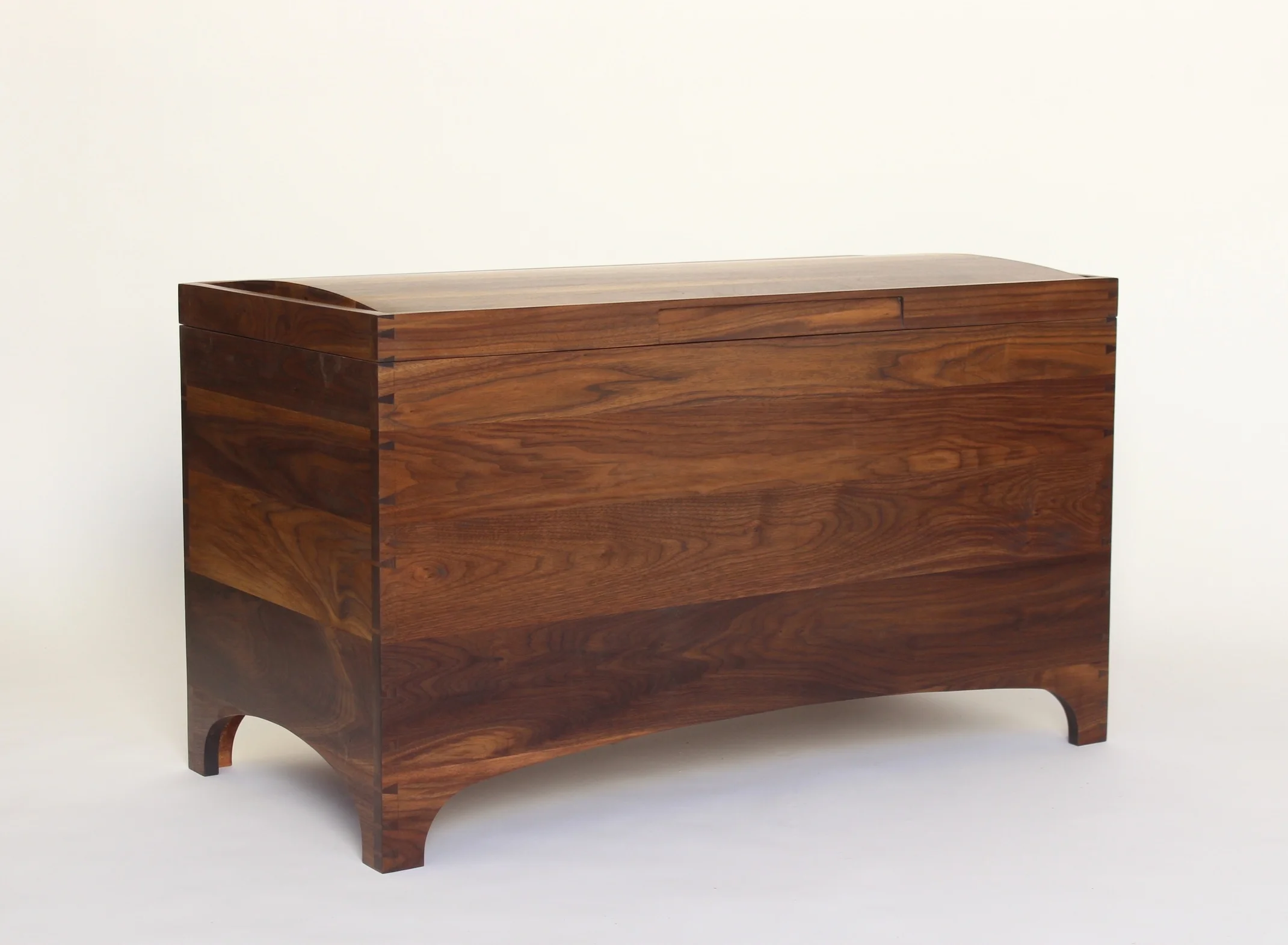 The gentle curve of the panel top reflects the lower curves to humanize the chest.