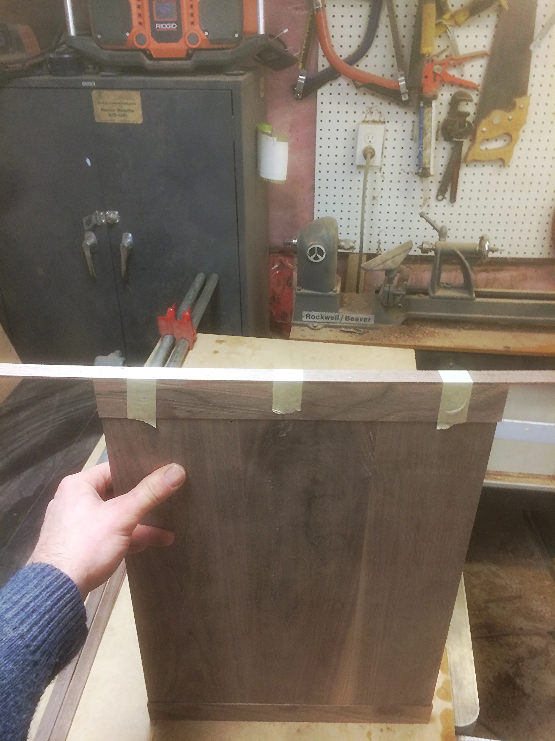 A thin layer of wood edge glued onto the panels edge seals in the magnets. I used rare earth magnets that are so strong, they work through the wood. 