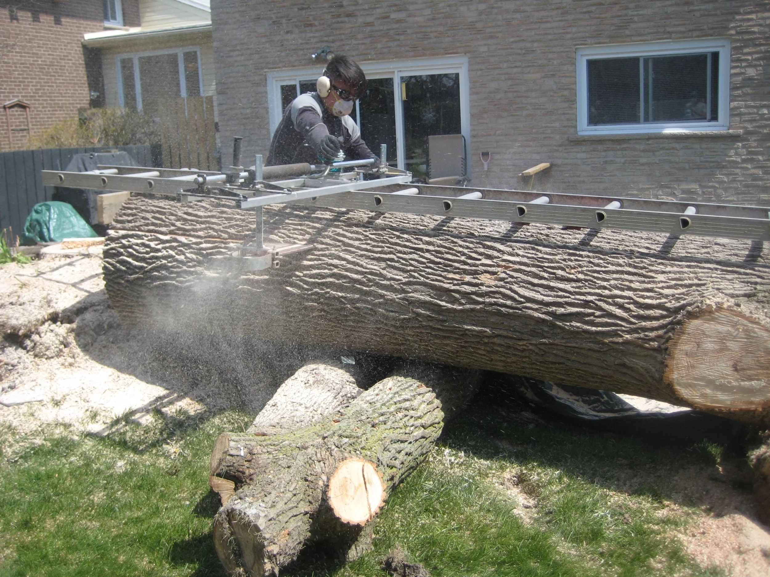 Here goes the first cut! See the mill is sliding on the ladder? This makes a level first cut. Without the ladder, the mill would rock side to side and there would be TROUBLE!