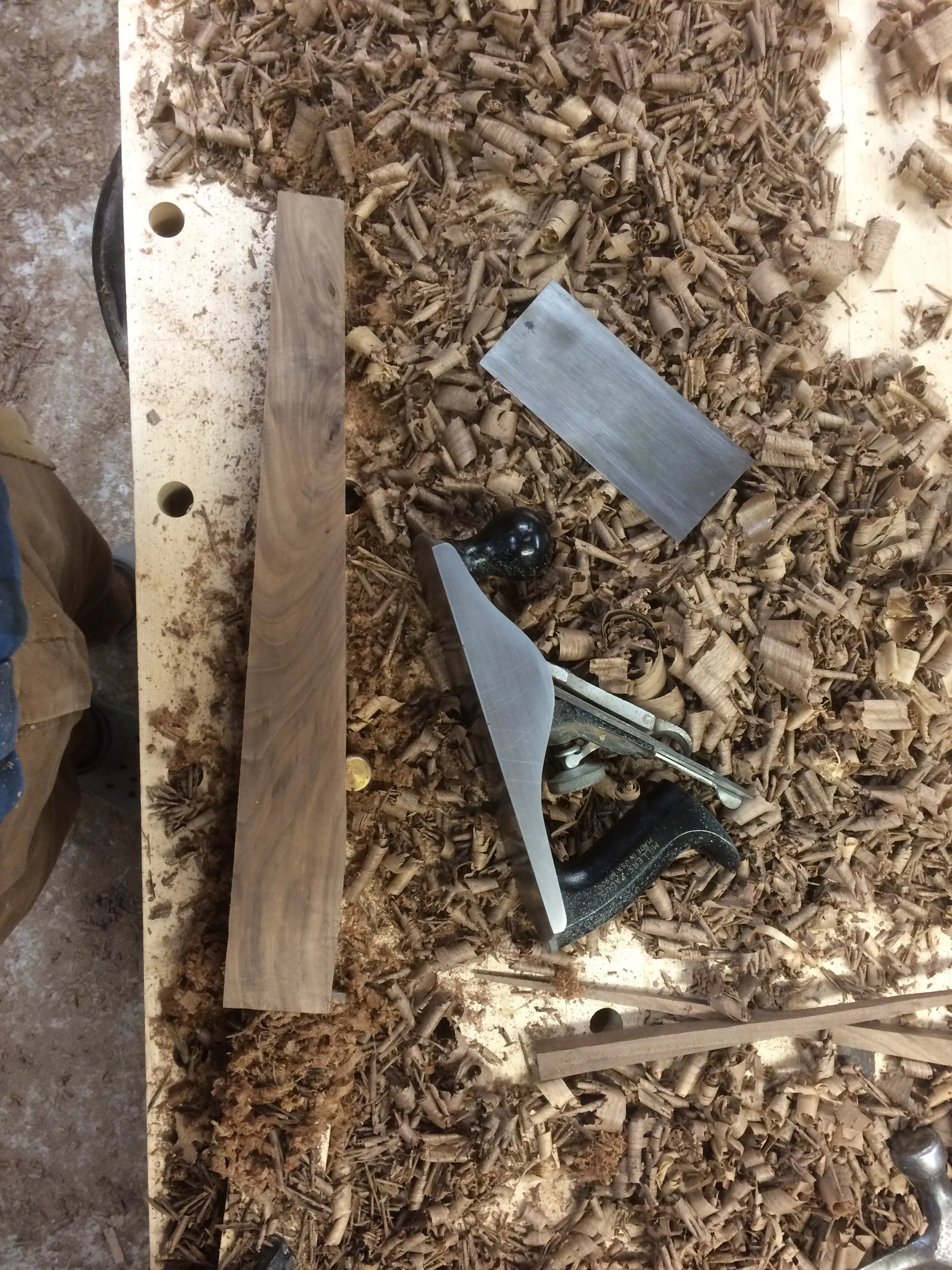 This shows a leg being smoothed after it was cut on the bandsaw. The hand plane does most of the work, and the card scraper cleans up any unusual grain. 