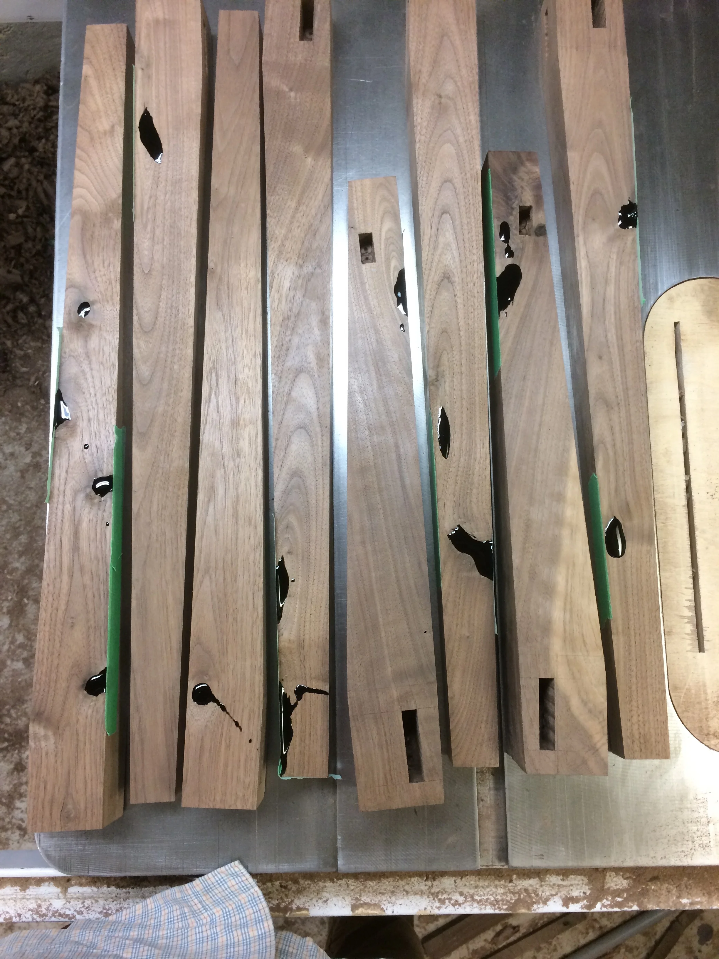 The liquid black epoxy dries hard and is then cleaned off to display perfectly filled holes. These legs needed lots of epoxy, but looked great in the end. 