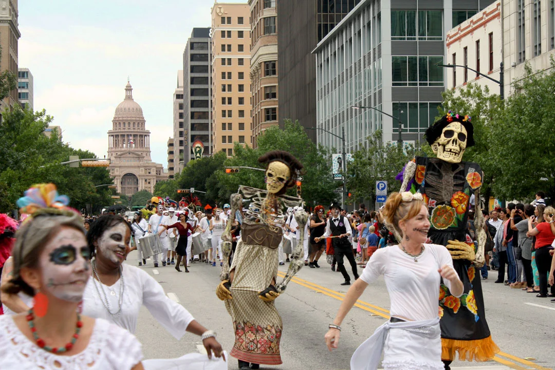 Image: Parade participants proceeding down Congress during Viva la Vida 2015. Photo by Sixto-Juan Zavala. 