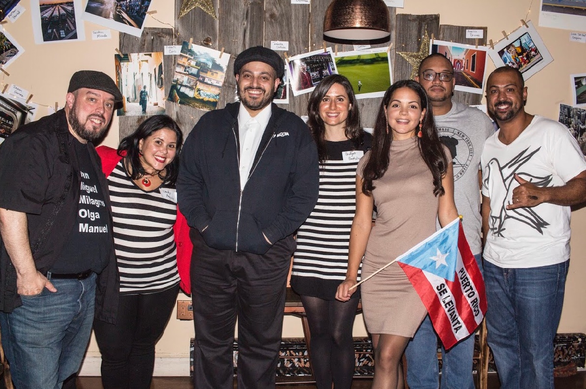 A little over a month and half ago, our Lead Curator Salvador Espinoza suggested that we organize a fundraiser for Puerto Rico to get help to the island after the devastation that was left behind created by Hurricane Maria. After some thought and preparation we came up with an idea for the Queens for Puerto Rico Relief Fund or #QU4PR. We teamed up to collaborate with Christian San Martin or otherwise known as The Visual Vandal, Bridget Bartolini of the Five Boro Story Project & Wendy Angulo of Wendy Angulo Productions and presented the #QU4PR photo and art gallery which focused on a dual theme of Queens community and Puerto Rican culture. The exhibit featured at two very different locations and two very unique venues in Queens. The first event took place at La Gloria Restaurant and Lounge in the heart of Jackson Heights, Queens. We choose La Gloria primarily because we were looking to collaborate with the talented and community driven Christian "Pookierazzi" San Martin. Also known as The Visual Vandal, Christian has hosted the popular Boulevard Brunch at the La Gloria for over a decade. Also invited to the first round of #QU4PR were Queens Village resident D.J. Dubbcity and D.J. Steph Cakes. While we were planning our first event, we were contacted by Paul Serelis, owner of Vintage Wine Bar. Paul supports a local charity every month by donating 33% of his earnings from a select red & white wine. Tabbed as the Wine of the Month program, Paul choose Queenscapes and the "Queens for Puerto Rico Relief Fund" as his charity to support in November. To compliment these efforts, Paul also invited us to host a second fundraising event at the end of November. Because our first fundraiser focused on engaging community through a celebration of cultures, we thought it would be interesting to go a different route with the second fundraiser and concentrate on community building. To flesh out a program with no music and crowd engagement, we invited Bridget Bartolini, founder of the Five Boro Story Project and Wendy Angulo of Wendy Angulo Productions and incorporated story telling and spoken word artists along with poets who supplied performances that supported our main theme of Queens community and Puerto Rican culture. Nelson Lugo, Jessie Cotto, George Torres, and Joselynn Cortes all turned in amazing performances. Their pieces served as a fitting precursor to a subsequent open forum discussion geared towards folks speaking on current community projects and or upcoming ideas. In two events, totaling seven hours, accompanied with Vintage's Wine of the Month Program, we were able to successfully raise $2,501.80. Below is the breakdown of all donation money collected: La Gloria Restaurant & Lounge 11/08 Entry, photo & raffle sales -$1,104.00 Domingo Carrasco & P.S. 129 - $500.00 Greater Astoria Historical Society - $100.00 Vintage Wine 11/30 Entry, photo & raffle sales - $314.00 Vintage Wine of the Month program - $433.80 Road to Greatness - $50.00 (100% of all money collected to be donated to @conprmetidos, a non partisan, non profit San Juan based charity.) Words by Adolfo Steve Vazquez Photo by Taranita Cosales