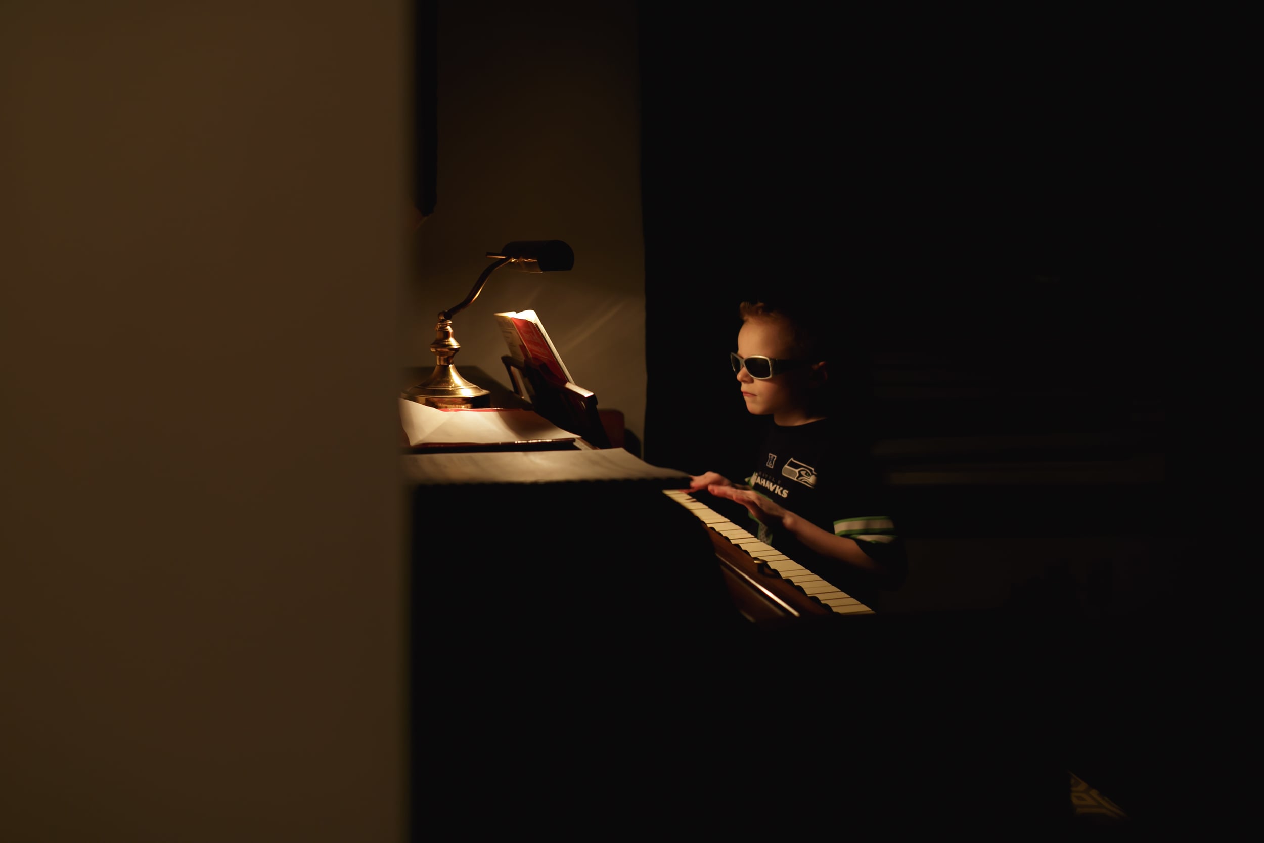 Ben started piano lessons. He's so cool he wears his sunglasses while he practices.