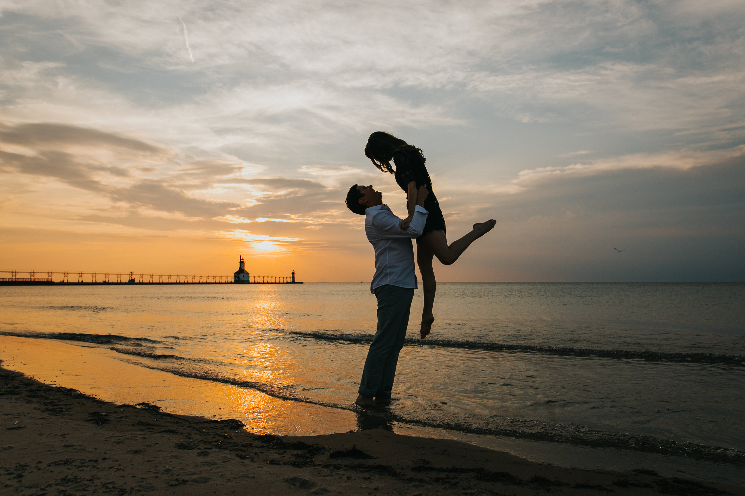 St. Joseph, MI engagement pictures, beach sunset silhouette, lighthouse, Lake Michigan