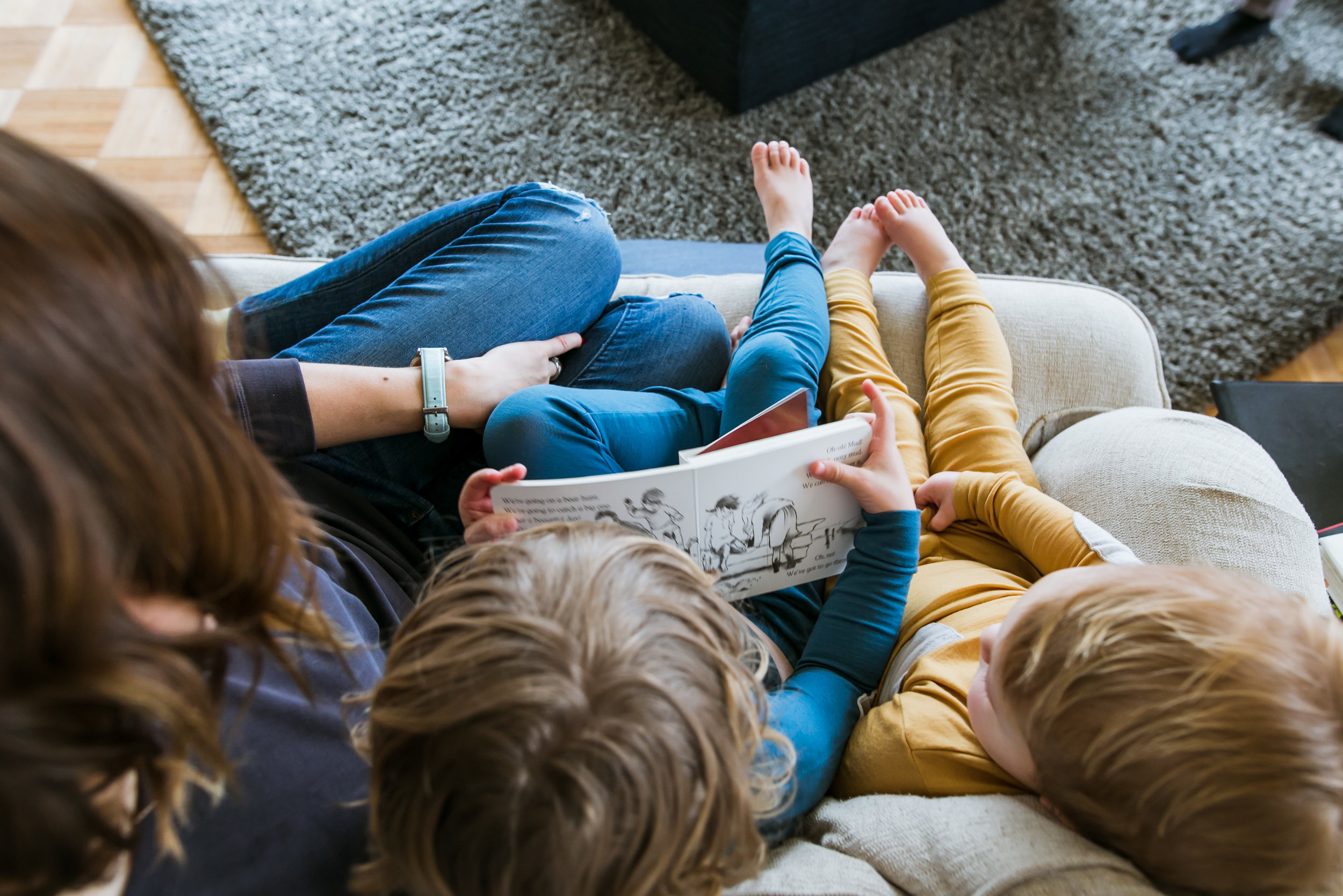 mom and boys reading book from above, family film session mishawaka