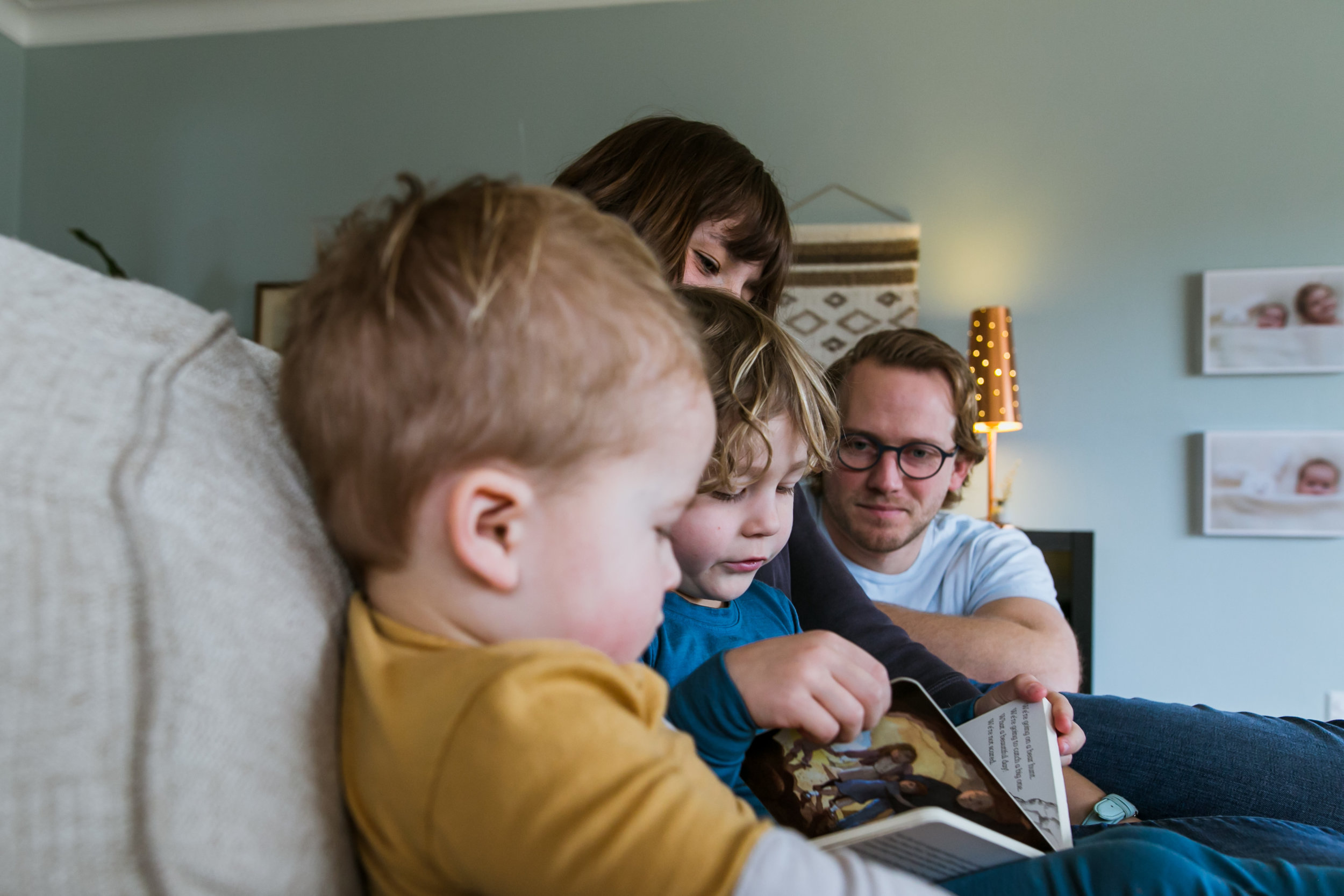 mom, dad and two sons reading book, family film session mishawaka