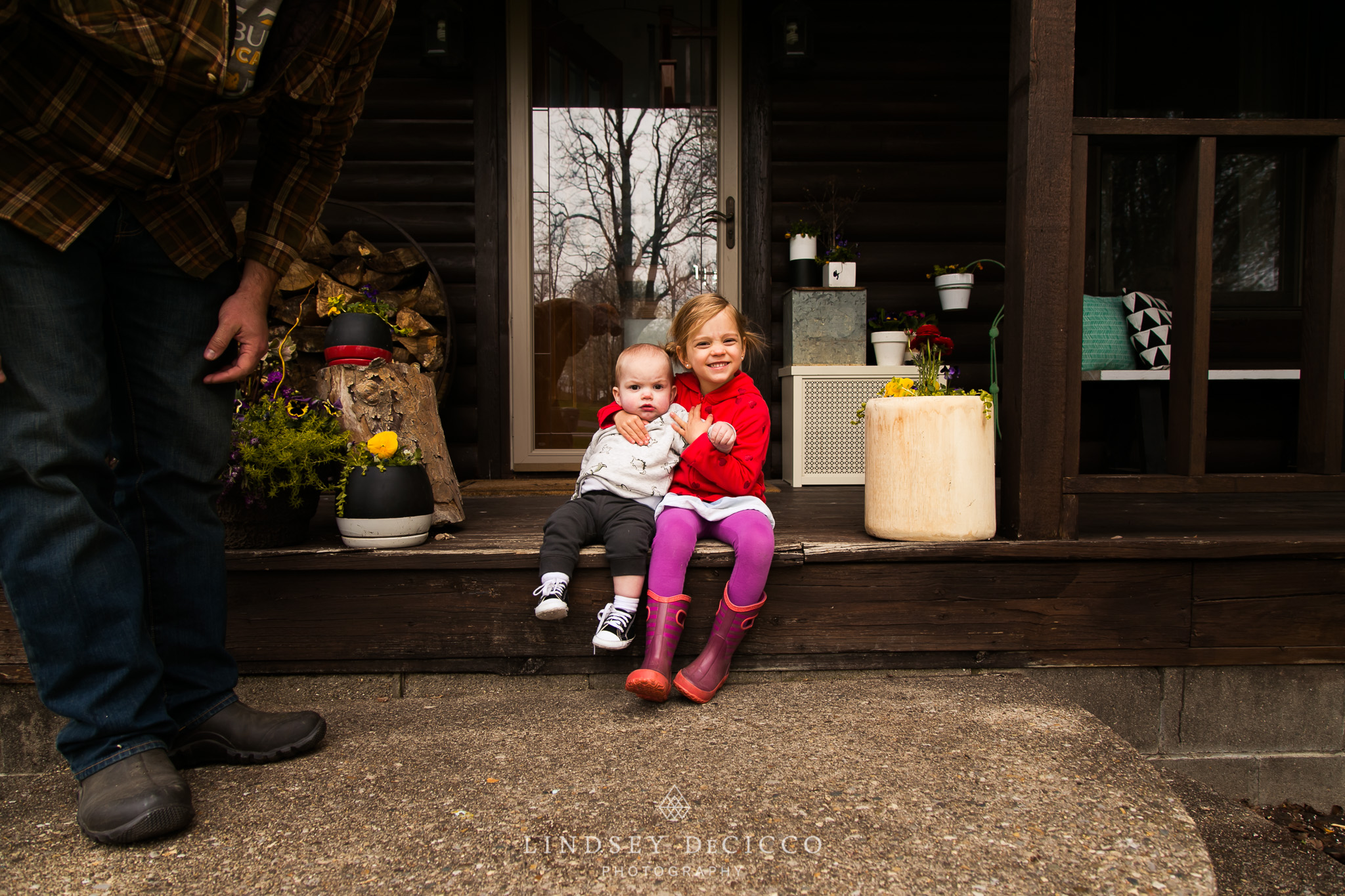 son and daughter on front porch of cabin