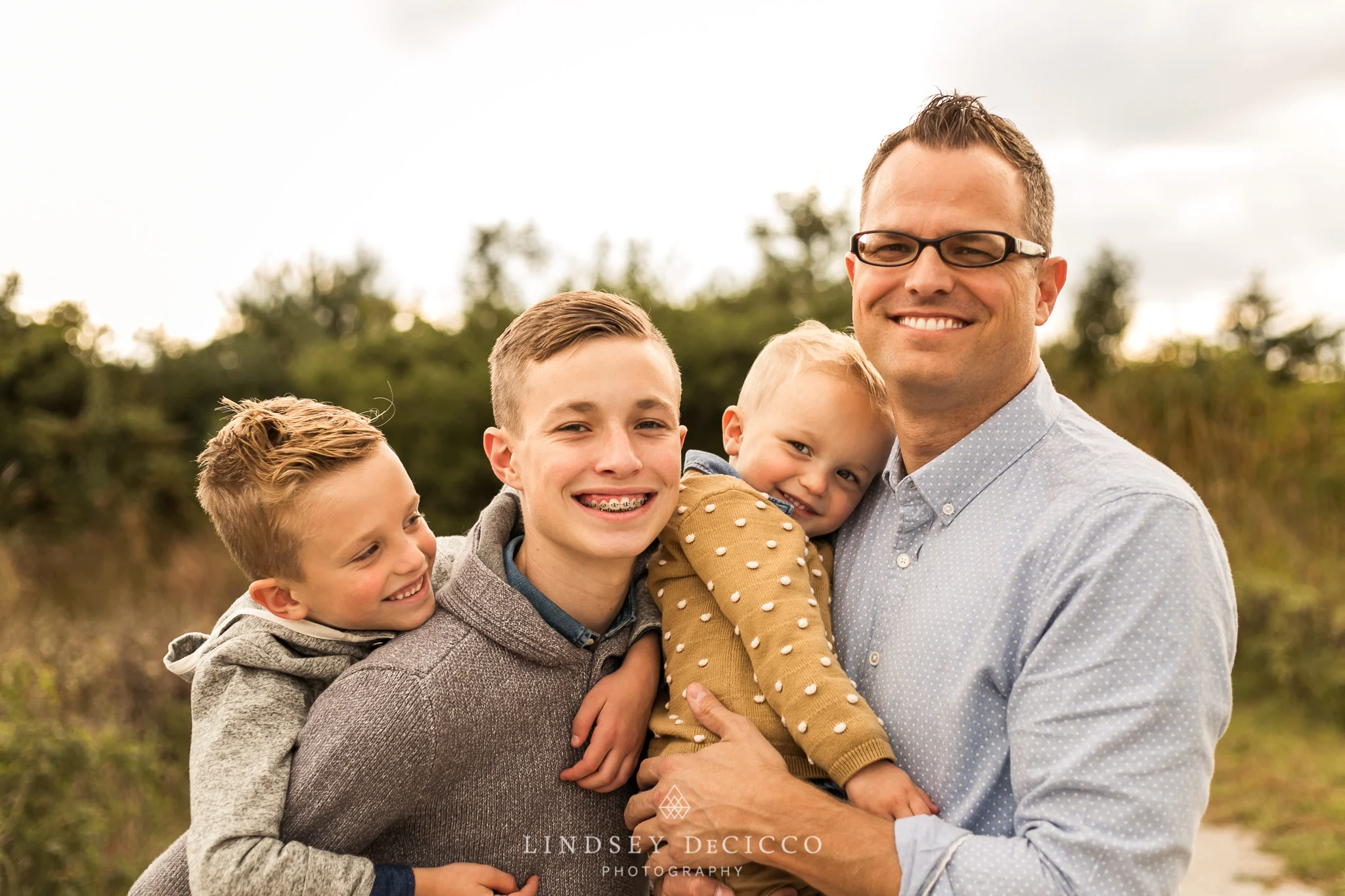 dad and 3 sons pose
