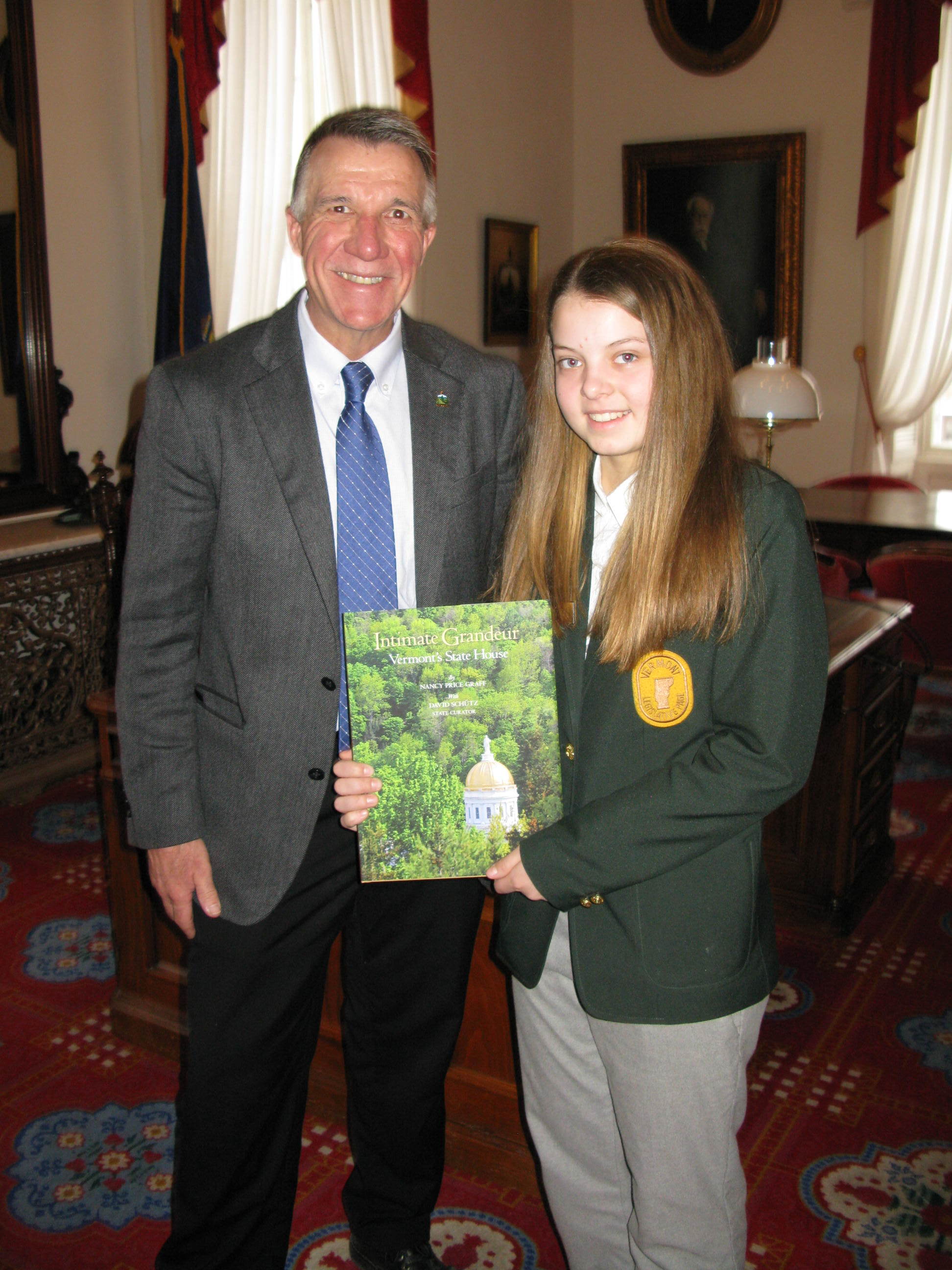 Governor Scott with Sabina and her copy Intimate Grandeur, the State House history. 