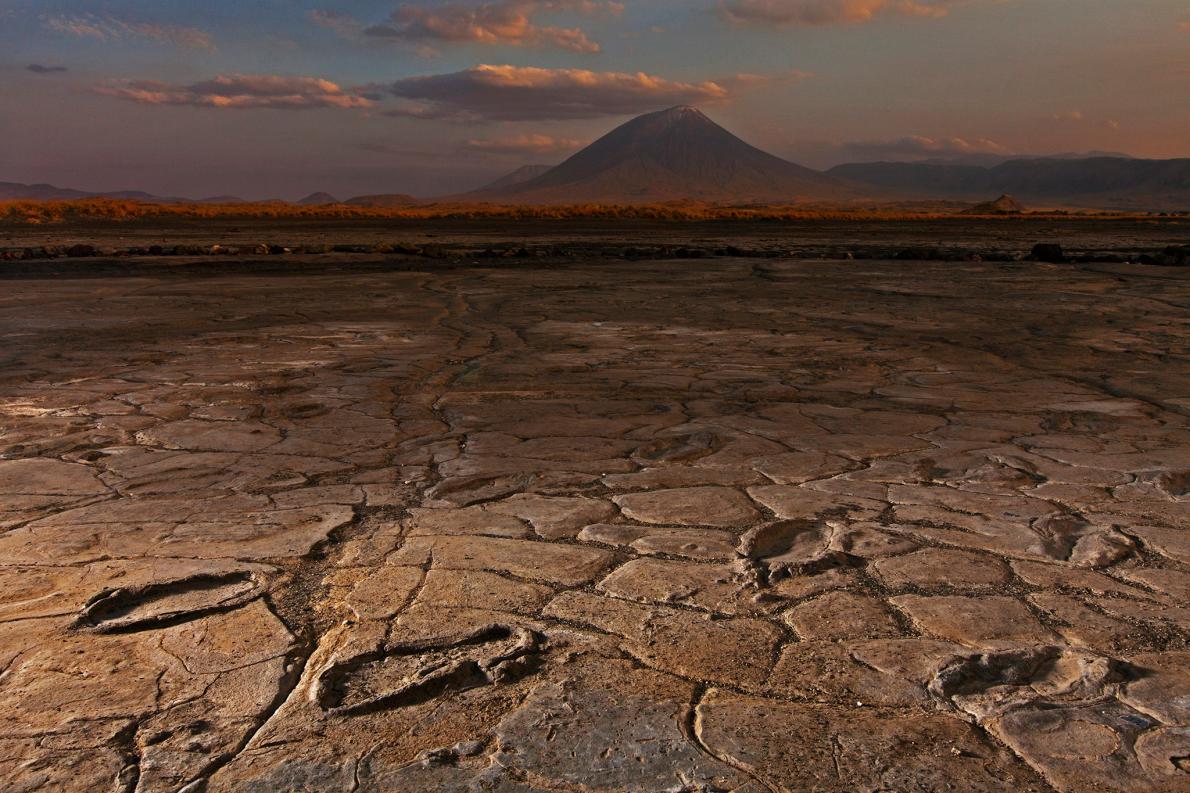 Mudflats in the shadow of the Ol Doinyo Lengai volcano captured a huge trove of ancient human footprints. PHOTOGRAPH BY ROBERT CLARK, NATIONAL GEOGRAPHIC CREATIVE