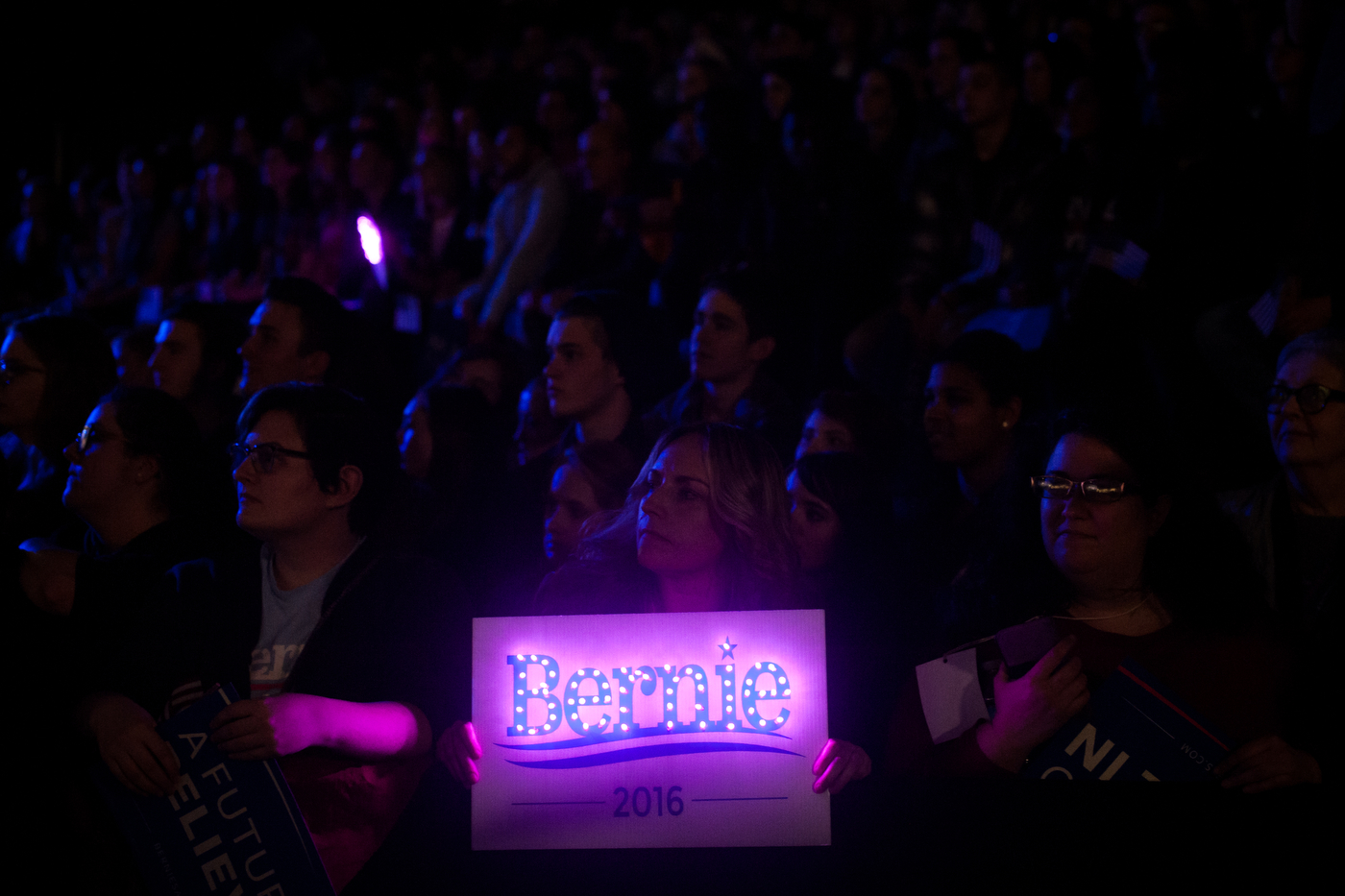  A supporter of Democratic U.S. presidential candidate Bernie Sanders holds a sign as a video plays before the start of a campaign rally and concert at the University of Iowa in Iowa City, Iowa on January 30, 2016.  