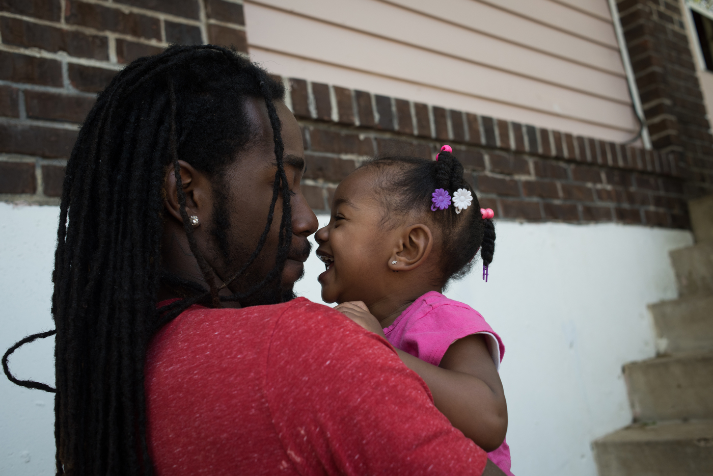 Raymond "Trip" Williams plays with his 18-month-old daughter Rayne at his grandmother's house in Ferguson, Mo. Trip, who is separated from Rayne's mother, recently secured a job in an effort to provide for his daughter better, motivated by seeing some of his friends grow up without both parents around.