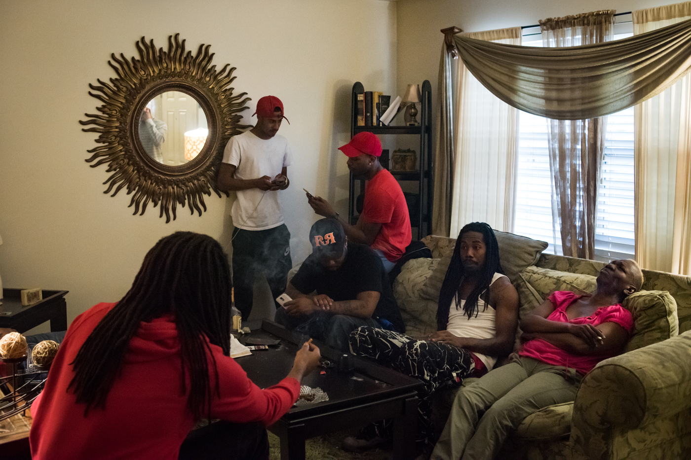 Friends hang out at the condo of Carlette Williams (right) at the Brentwood Townhomes in Ferguson, Mo. William's sons' friends are the sons of many of her former drinking and smoking buddies from when she was that age.