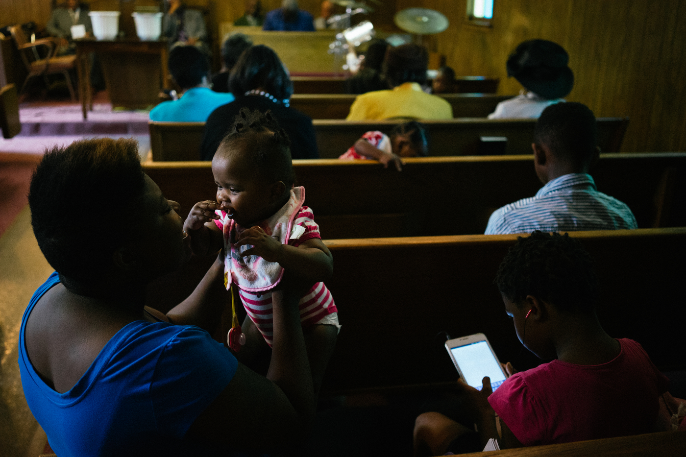 A woman plays with her granddaughter during Sunday worship in Ferguson.