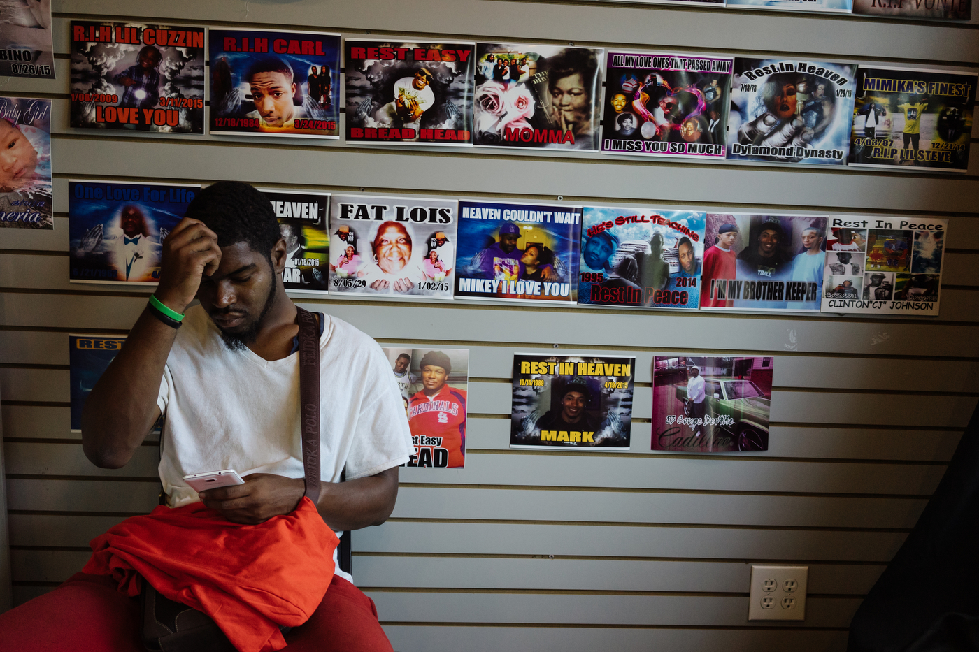 Posters of memorials are pasted to the wall at a local business that specializes in printing memorial t-shirts, a large portion of which are for young men who have been killed by gun violence in Ferguson and surrounding neighborhoods.