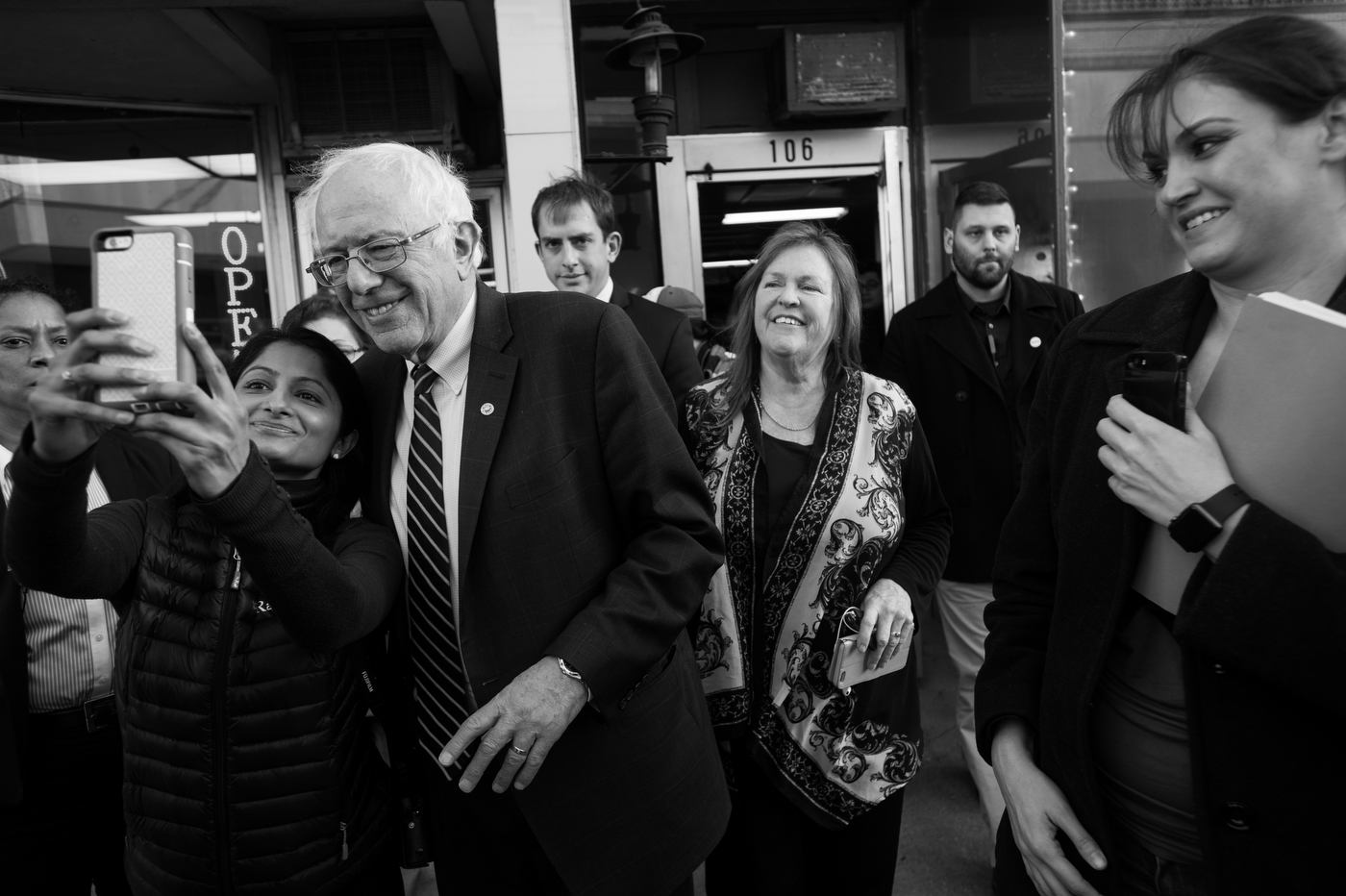  A woman grabs Democratic presidential candidate Bernie Sanders for a selfie as he and his wife Jane, center, leave a campaign event at a local campaign office in Muscatine, Iowa on January 29. 