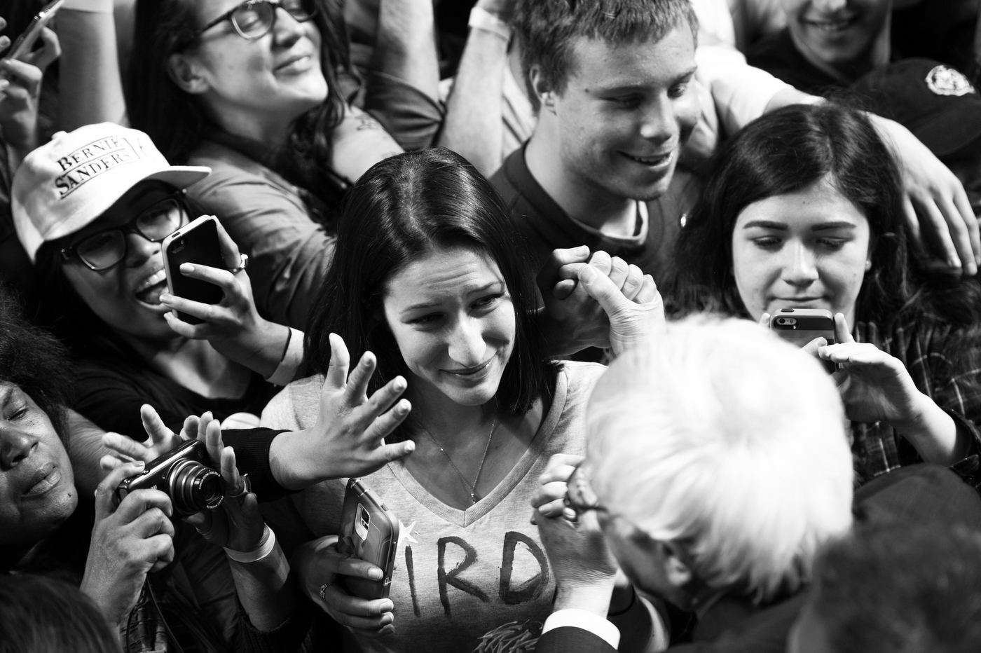  A young woman, who spent much of the rally crying with joy, gazes as she holds the hand of Democratic presidential candidate Bernie Sanders after a rally at Temple University in Philadelphia, Pennsylvania on April 6. 