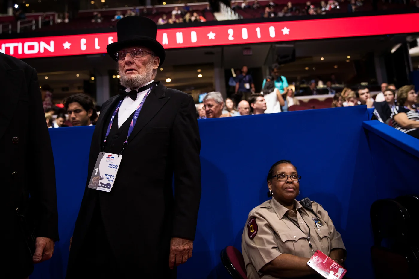 A Missouri delegate, dressed as former U.S. President Abraham Lincoln, and a security guard watch the crowd of the Republican National Convention in Cleveland, OH.