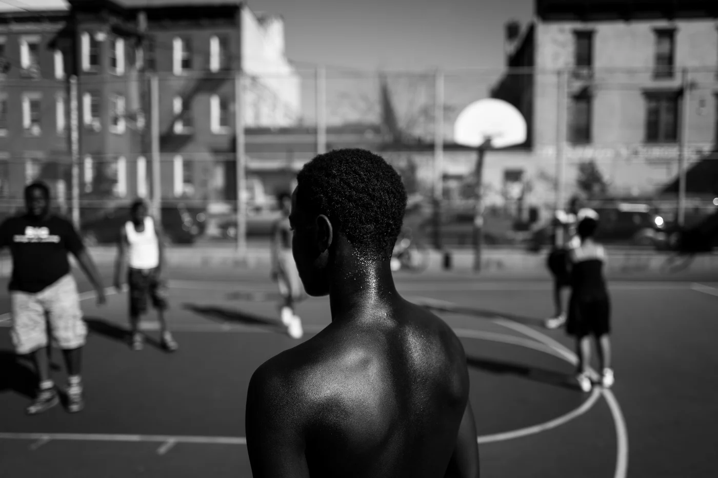 A young man pauses during a game of streetball at the park in Bushwick, NY.