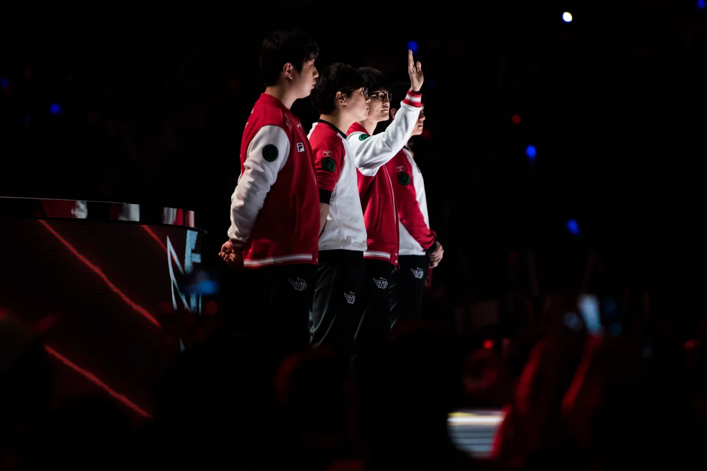 Lee "Faker" Sang-hyeok, second from right, likely the greatest player in the history of League of Legends, waves to the crowd ahead of his team's semifinal match.