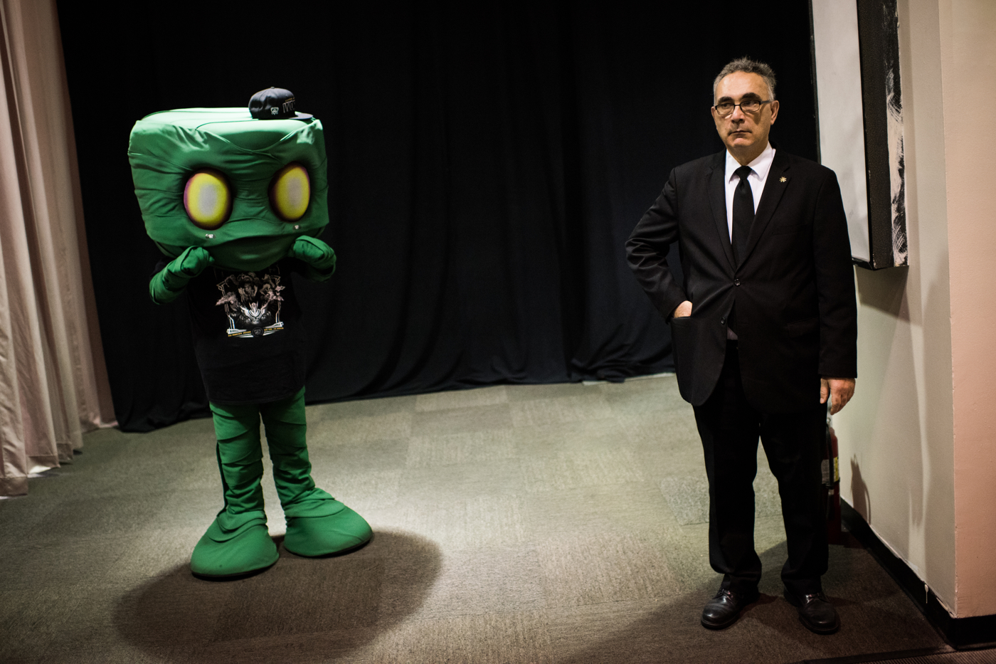  A security guard stands next to a person cosplaying as Amumu, a champion from League of Legends. 