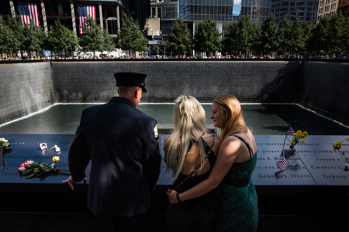 A woman comforts her sister as they gather at the National September 11 Memorial in Manhattan, New York, September 11, 2016, on the 15th anniversary of the terrorist attacks on September 11, 2001.