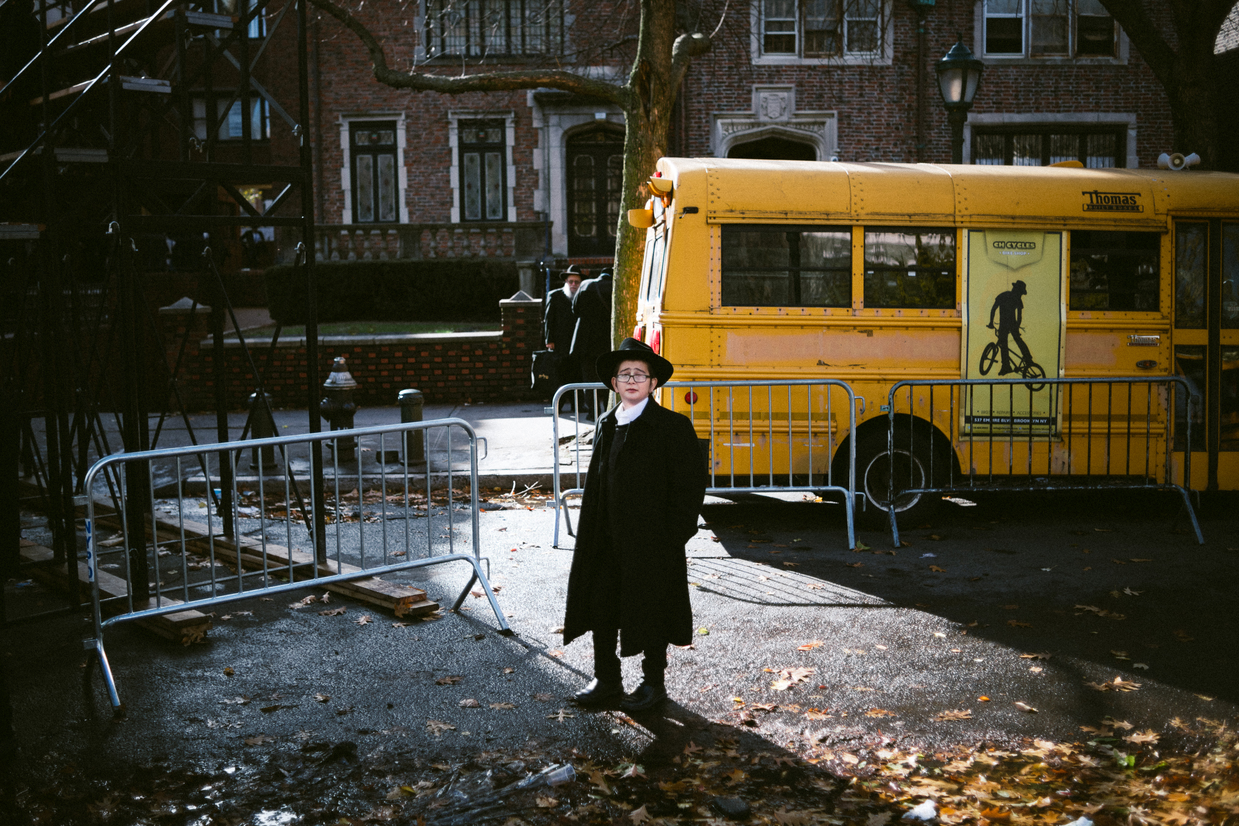  A young Chabad-Lubavitch boy, stands near a school bus after watching the a group photo of thousands in front of the movement's headquarters in the Crown Heights neighborhood of Brooklyn, NY. 