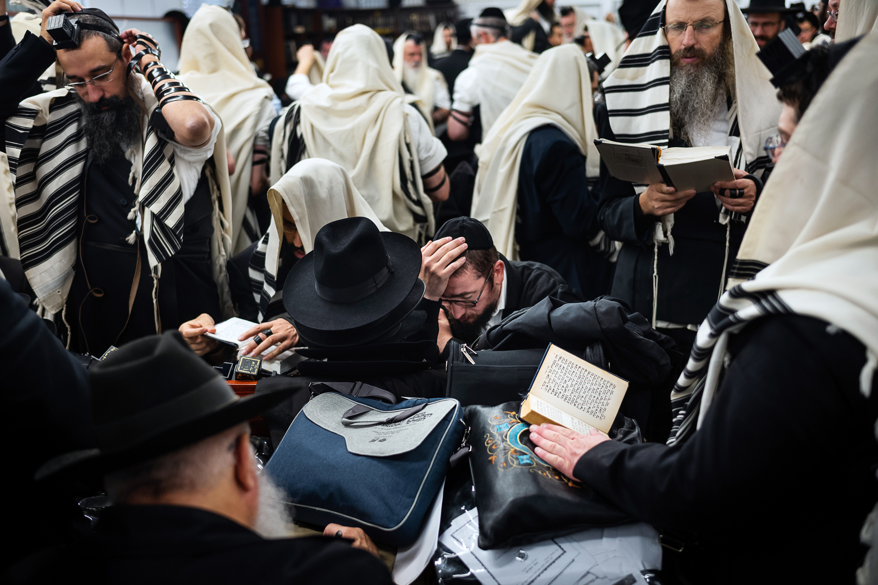  Chabad-Lubavitch rabbis read from prayer books in a building near the gravesite of the Lubavitcher Rebbe, Rabbi Menachem M. Schneerson, in Queens, NY. 