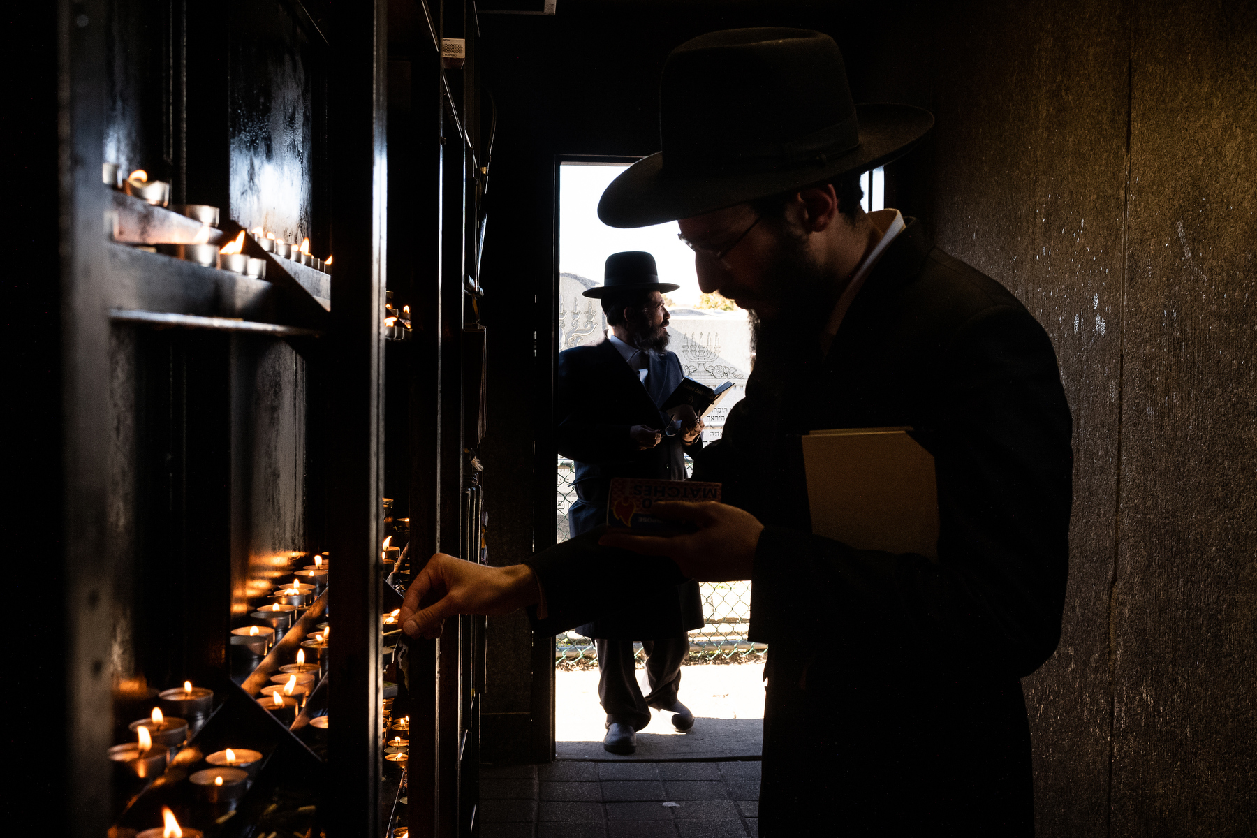  A Chabad-Lubavitch rabbi light candles as he prepares to pray at the Ohel, the gravesite of the Lubavitcher Rebbe Menachem M. Schneerson in Queens, NY. 