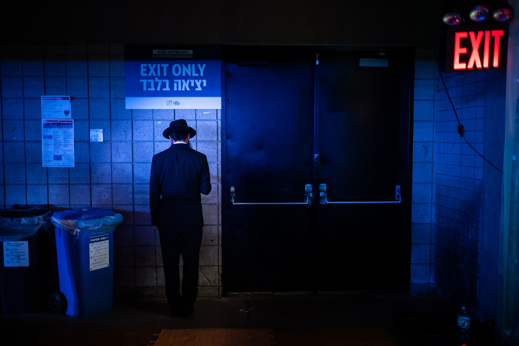  A Chabad-Lubavitch rabbi prays in a corner as thousands gather for a banquet in Suffern, NY. Each year, the International Conference of Chabad-Lubavitch Shluchim, or emissaries, takes place in the New York City area for six days. 