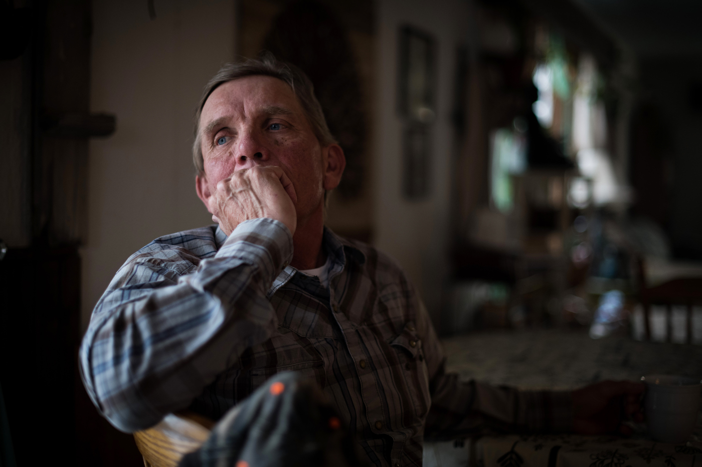  45º32'31.3"N 102º29'52.1"W. 110 miles from the nearest McDonald's.  Sion Hanson sits in a neighbor's home and drinks coffee before dinner in Bison, SD on April 6, 2018. A maintenance worker for the city of Bison, he wakes up early every morning to d