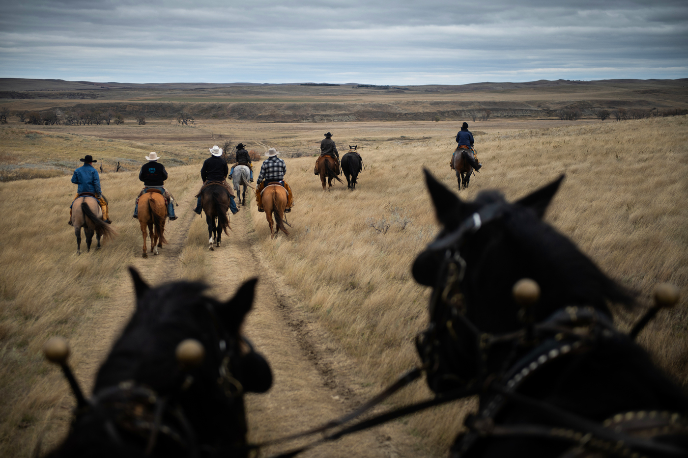  Pallbearers for Gregg Seim, 61, ride horses and lead a riderless horse to his internment at the Seim Family Cemetery in Shadehill, SD. 