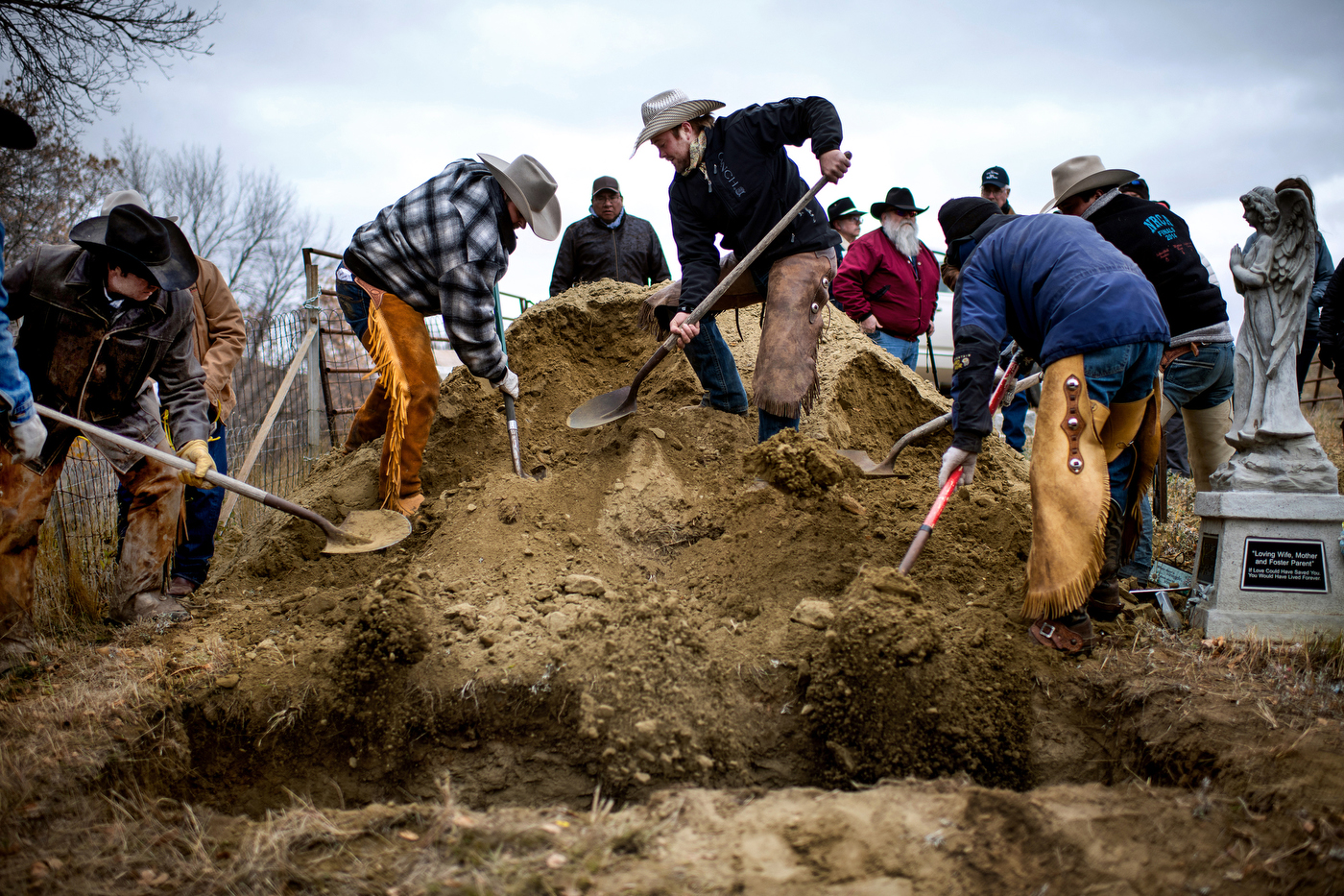  Friends cover the grave of Gregg Seim, 61, during his internment at the Seim Family Cemetery in Shadehill, SD on October 13, 2018. 