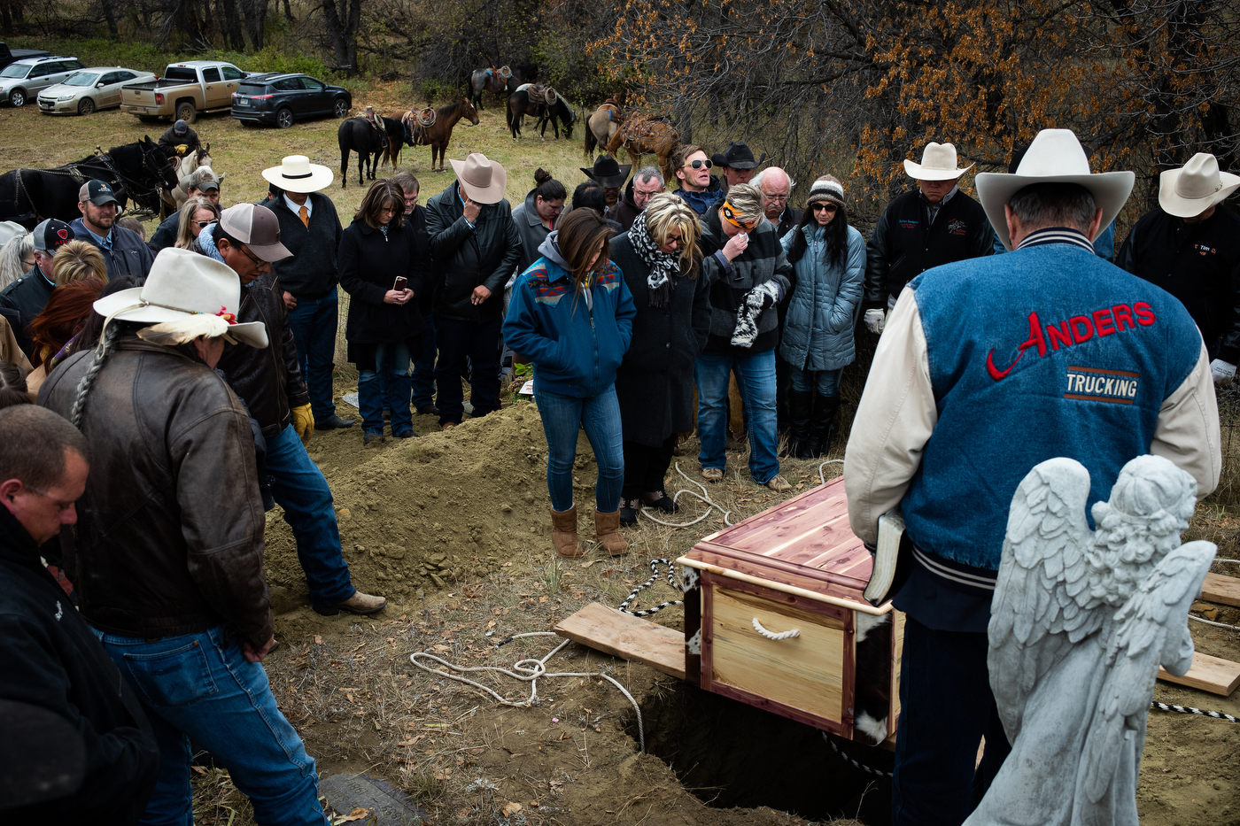  Mourners gather around the grave of Gregg Seim, 61, during his internment at the Seim Family Cemetery in Shadehill, SD. 