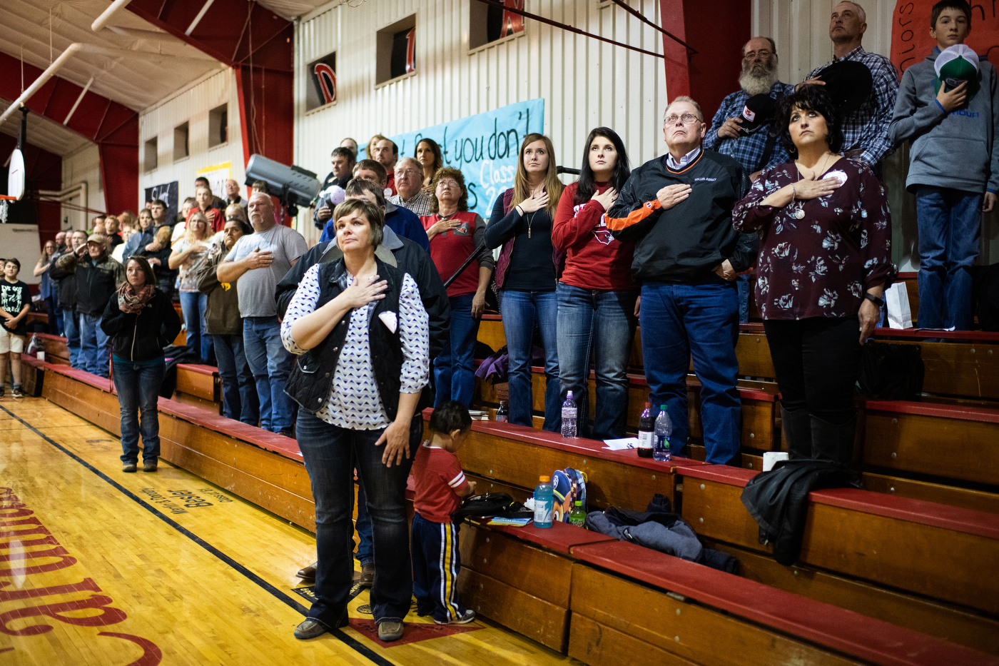  People stand for the national anthem at the Bison Cardinals varsity volleyball game against Mott-Regent High School in Bison, SD. 