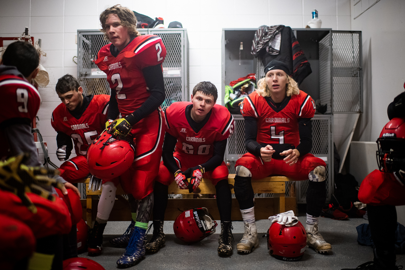  Players take a break in a high school locker room during the Bison Cardinals’ game versus northern rivals, the Lemmon-McIntosh Cowboys in Bison, SD. 