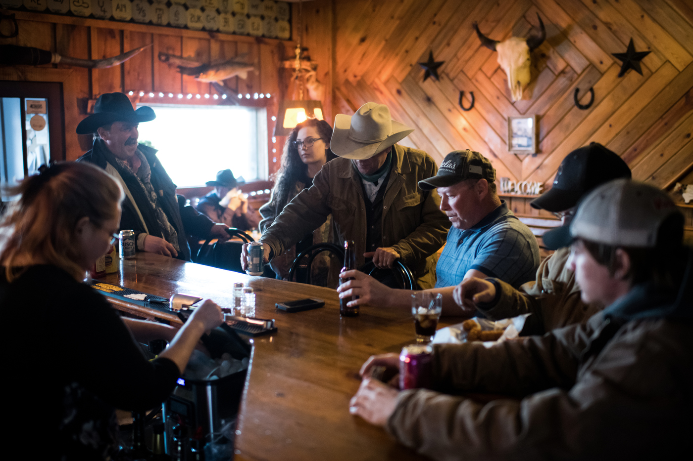  45º31'48.9"N, 102º12'59.8"W. 123 miles from the nearest McDonald's.  Men drink at Smoky's Bar and Grill during an uncommon break during the spring calving season in Meadow, SD on April 15, 2018. Winter has dragged on into mid-April in South Dakota a
