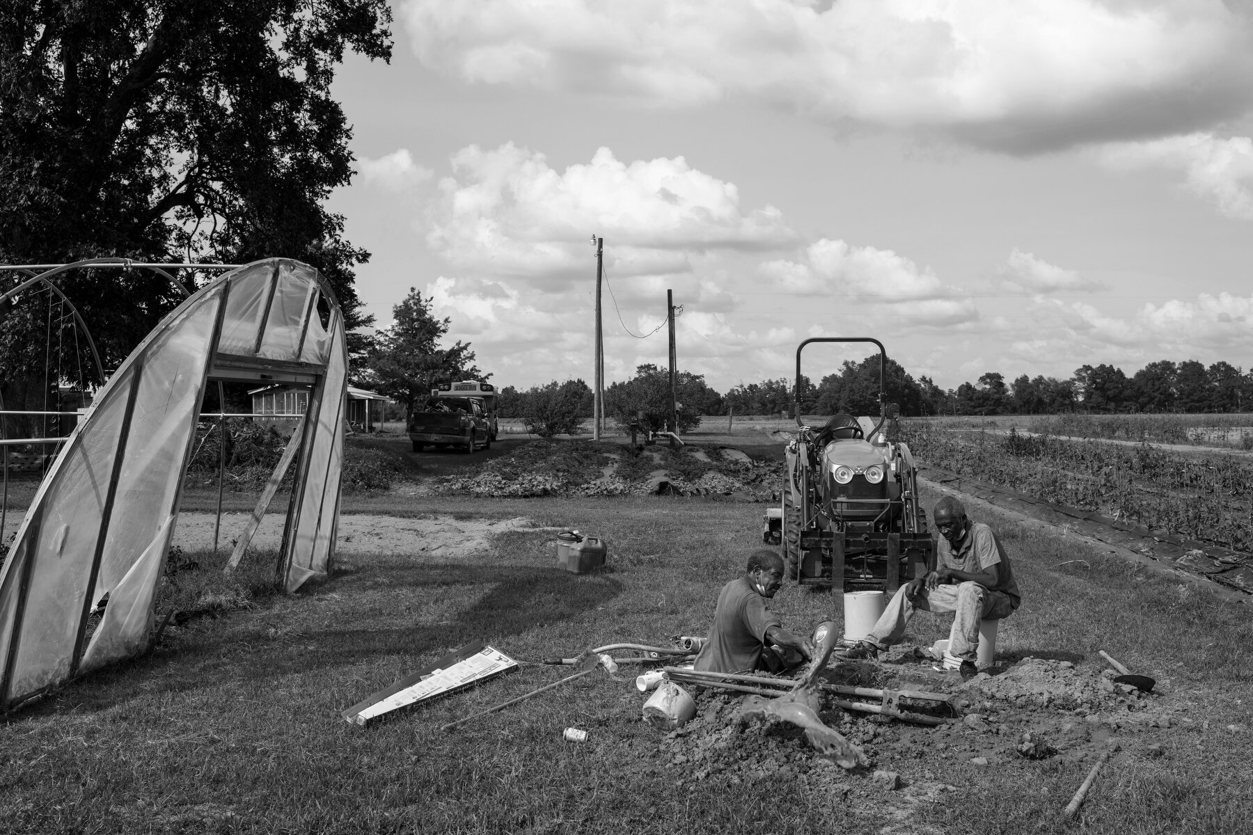  Two men work to fix a broken irrigation pump on Robbie Pollard’s farm in Marks, MS. Pollard runs a small farm growing consumable vegetables to sell and distribute throughout the region to help provide fresh produce in a food desert where a lack of a