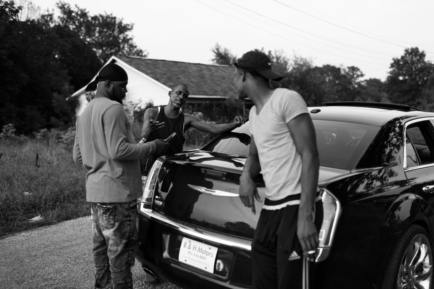  A group of men socialize in Darling, MS. Community gatherings largely occur outside in the cooler hours of the day in the Mississippi Delta like this night where bottles of whiskey and other liquor were passed around between friends. 