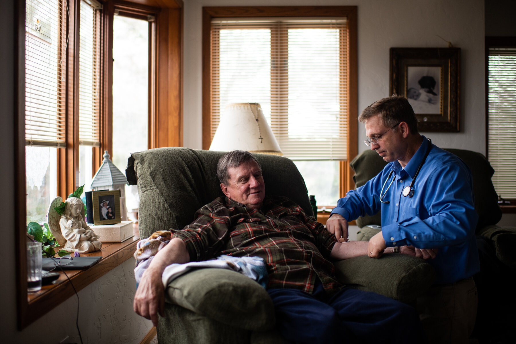  Dan Kvale, PA, performs a house call on James Wishard who was unable to make it into the office for a checkup and blood work due to water retention and pain in his feet in Bison, SD. Wishard is suffering from three different types of cancer, though 
