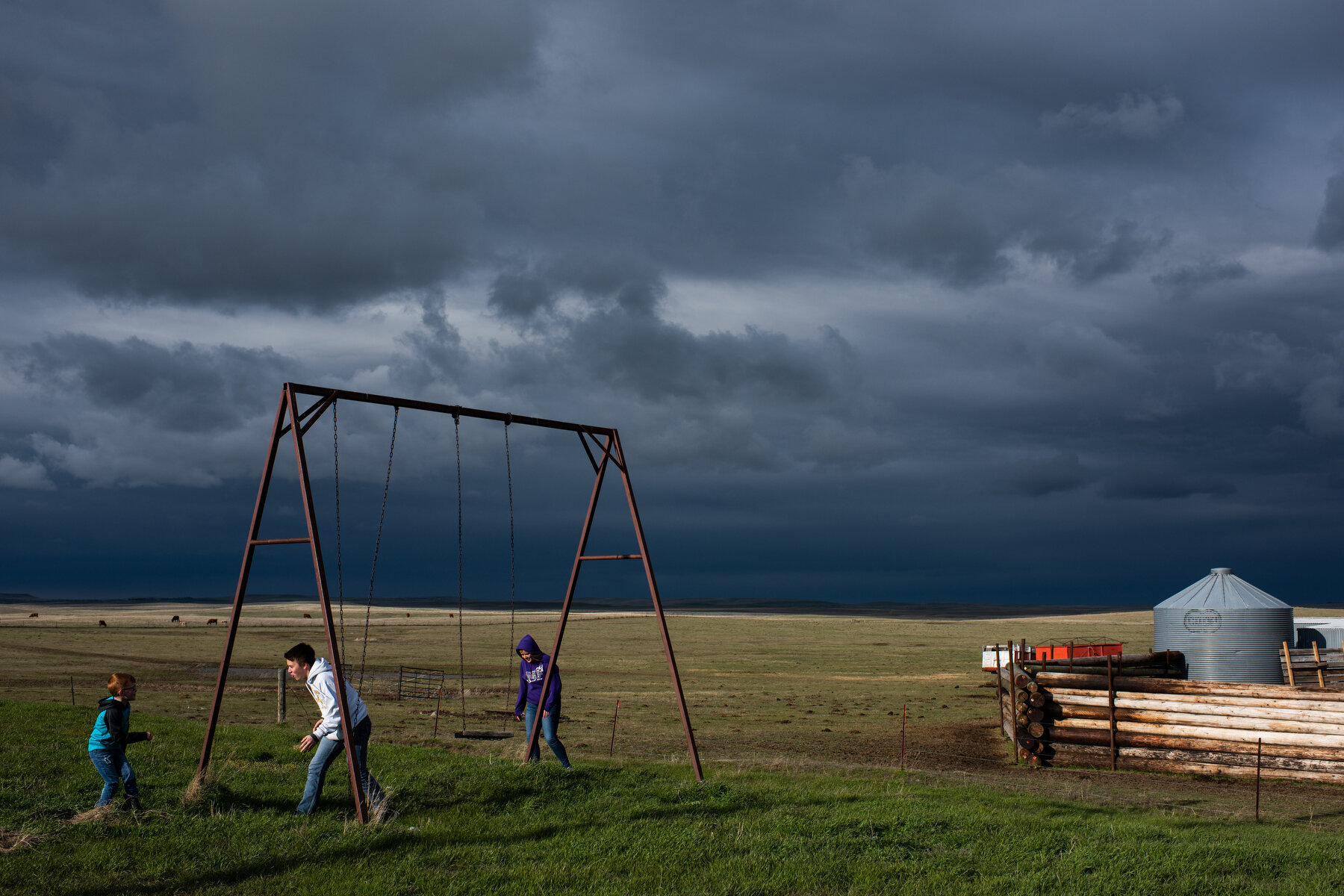  Children play on a swing set on the Lundberg ranch during Tallie Lundberg's graduation in Glad Valley, SD on May 11, 2019. 