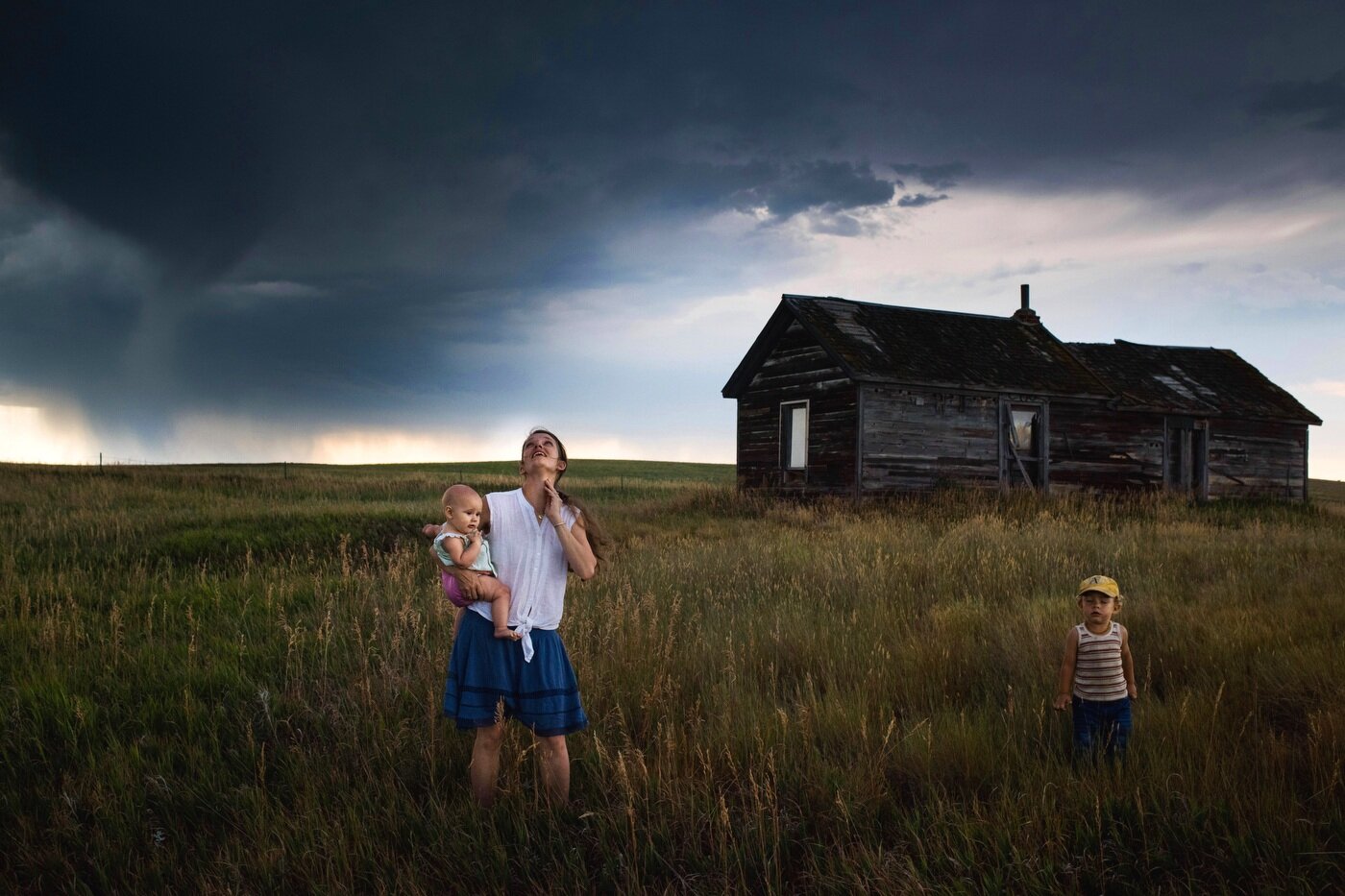  45º33'14.2"N, 102º30'36.1"W. 114 miles from the nearest McDonald's. Eliza Blue holds her daughter Emmy as her son Wesley closes his eyes and feels the coming storm winds on his face as they stand near an abandoned farmhouse on their leased land in B