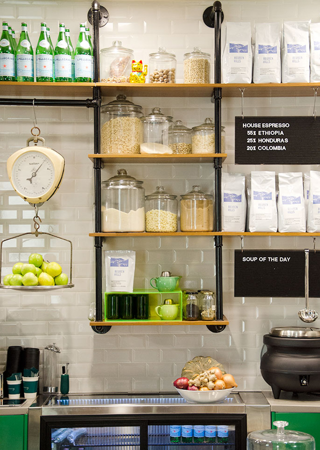 Gramercy's ingredients neatly displayed in glass jars on custom pipework shelving. Photo: Ezra La Vin