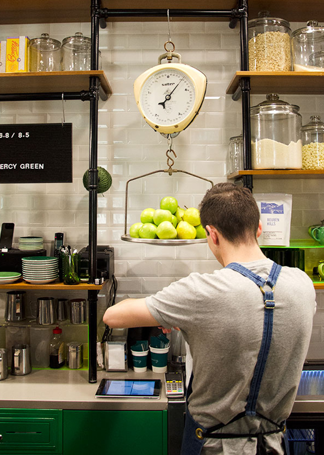 Mitch hard at work beneath a vintage scale laden with colour-appropriate fresh produce. Photo: Ezra La Vin