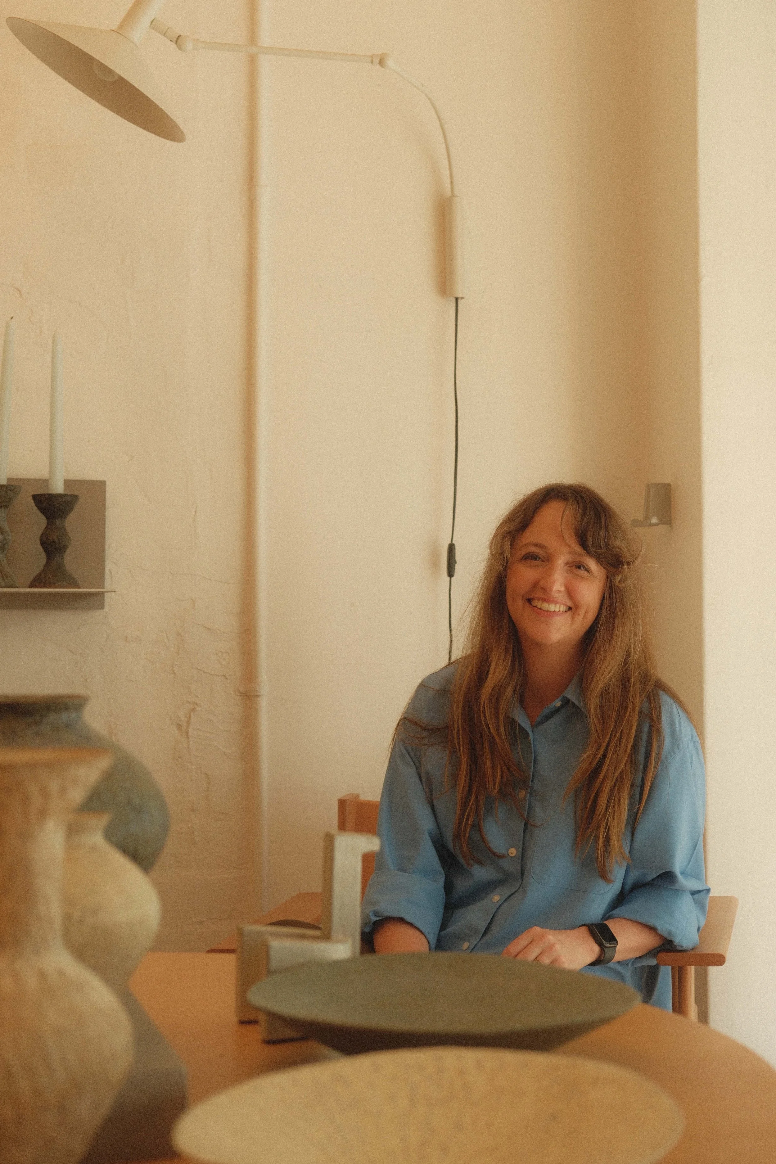 Interior Designer Georgia Cannon sitting in a showrooom